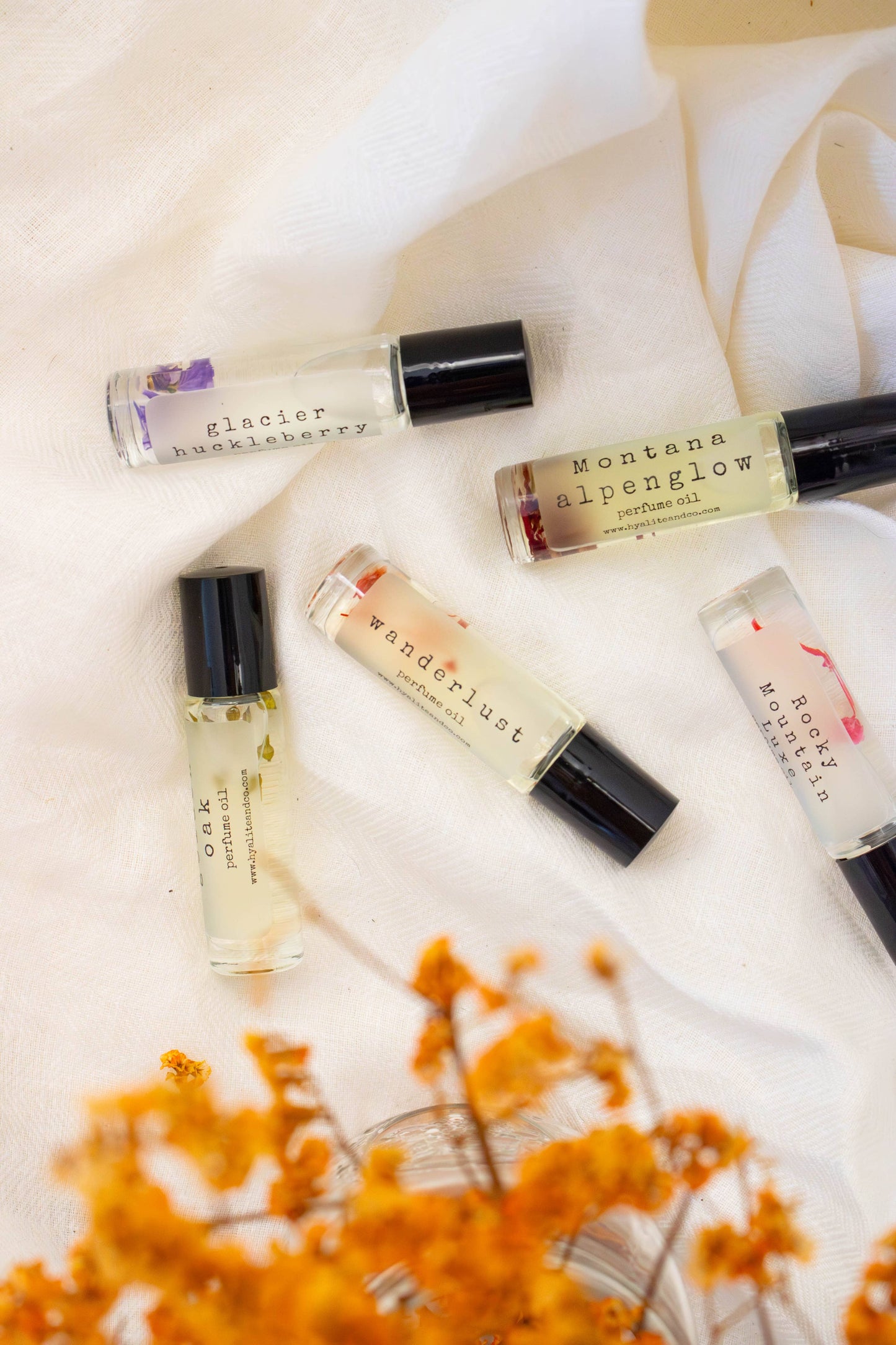 Hyalite & Co roll-on perfume oil with a sleek glass bottle, featuring a silver rollerball for easy application and elegant design.