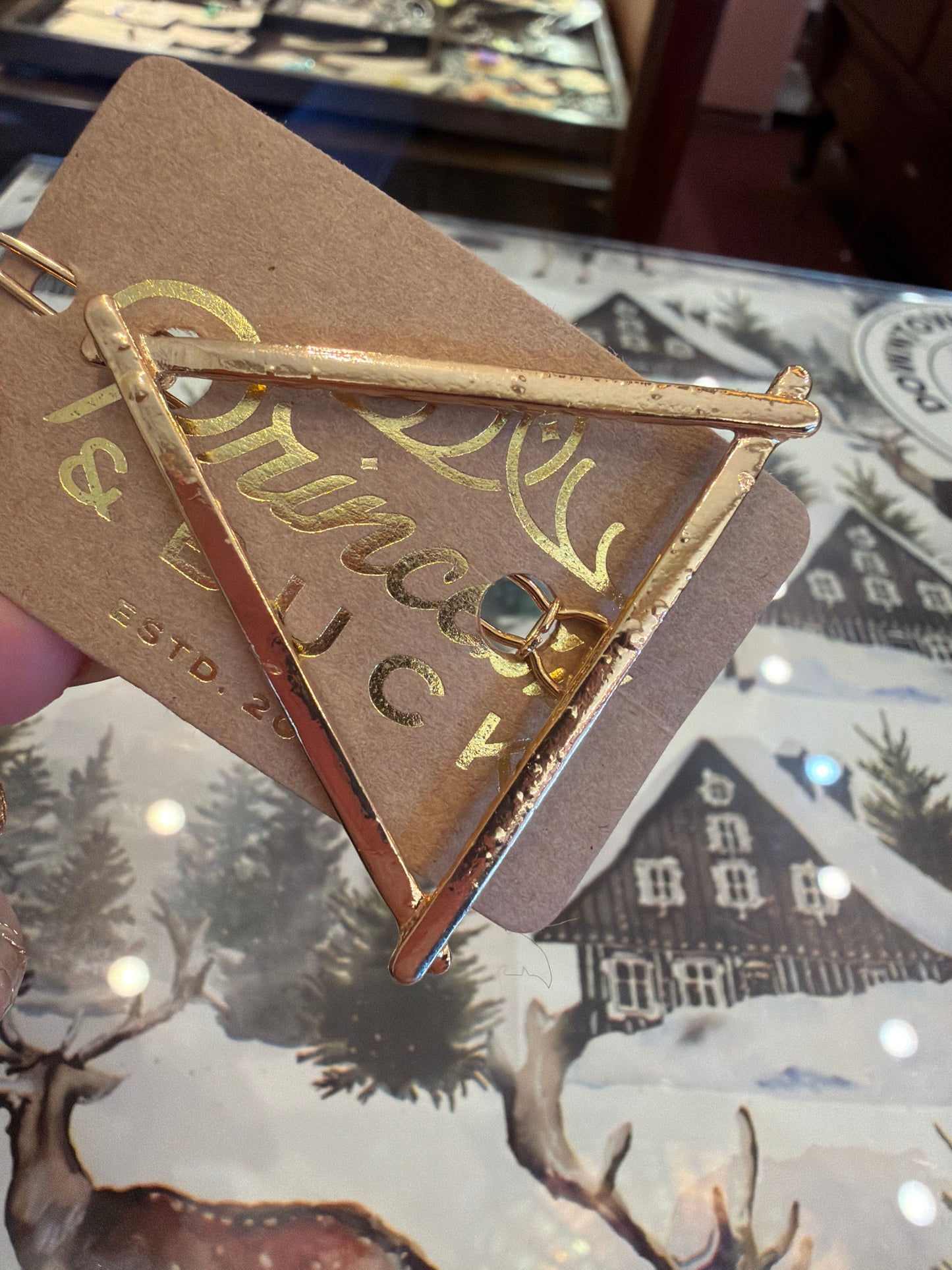 A Sparkling Mess triangle hairclip with a shiny, geometric design secured in hair, showcasing its stylish, modern accessory style.
