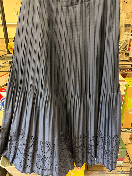 Navy eyelet maxi skirt by Current Air featuring a flowing design and eyelet detailing, displayed on a mannequin.