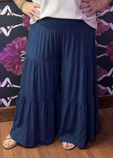 Camille & Co. tiered rayon pants in flowy, layered design, shown in full view on a neutral background.