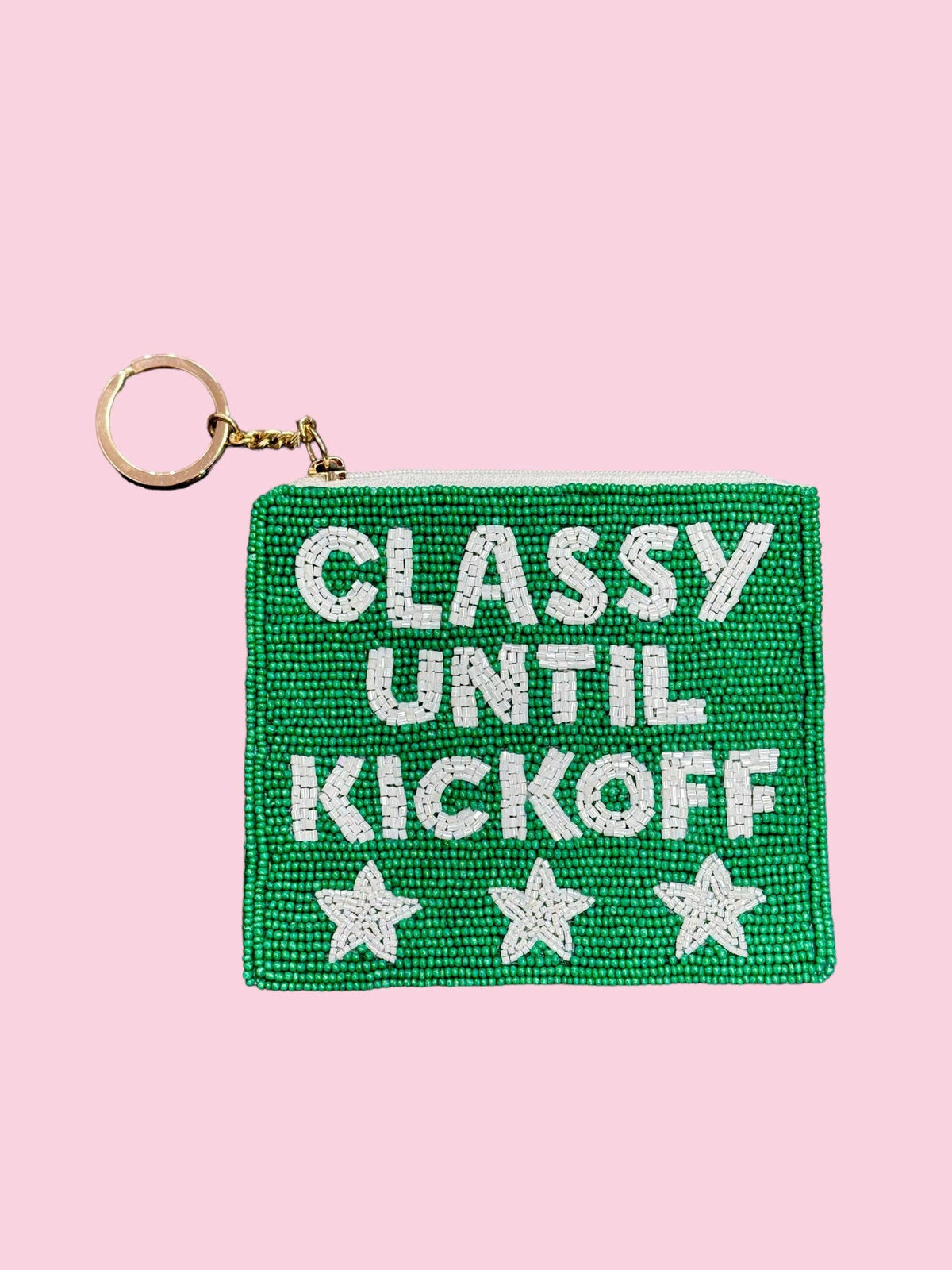 A square beaded coin purse in bright green with white seed-bead lettering reading "Classy Until Kickoff" and three white beaded stars along the bottom, featuring a top zip closure and a gold-tone keyring with chain link attachment.