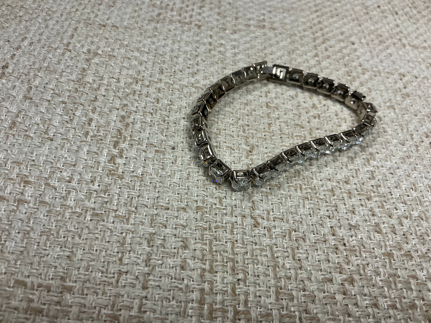 Silver "Tennis Anyone?" bracelet by Soiree Line featuring delicate tennis-themed charm and chain design.