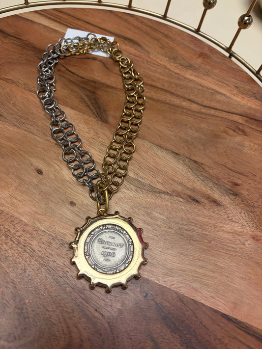Lula 'n' Lee Hainaut 1906 necklace featuring vintage-inspired design with intricate metalwork and decorative charms.