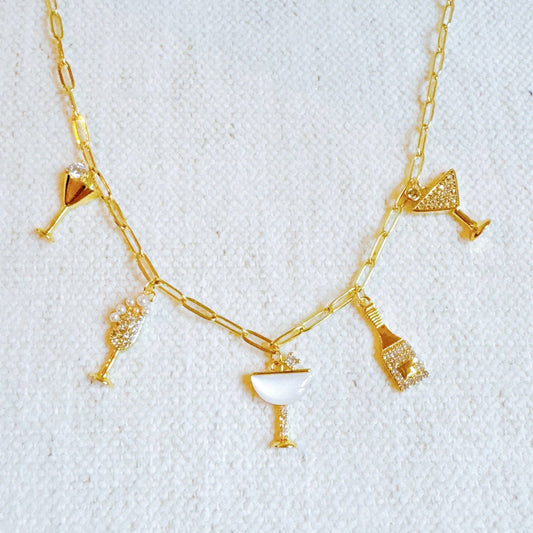 Ellison+Young Cheers To Happiness multi charm necklace with colorful charms on a silver chain, close-up view.