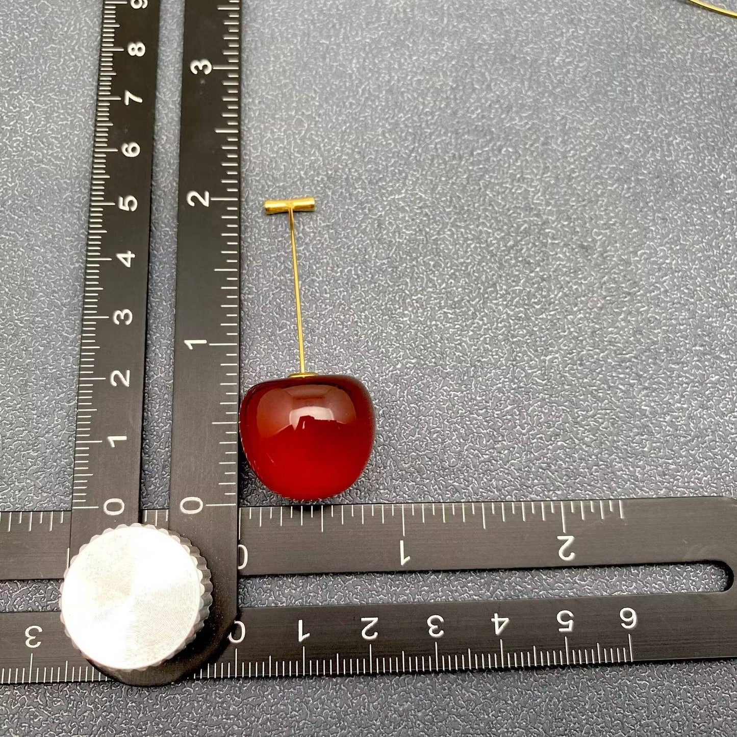 Cherry resin earrings by Mio Queena featuring vibrant red resin with a delicate earring hook design.