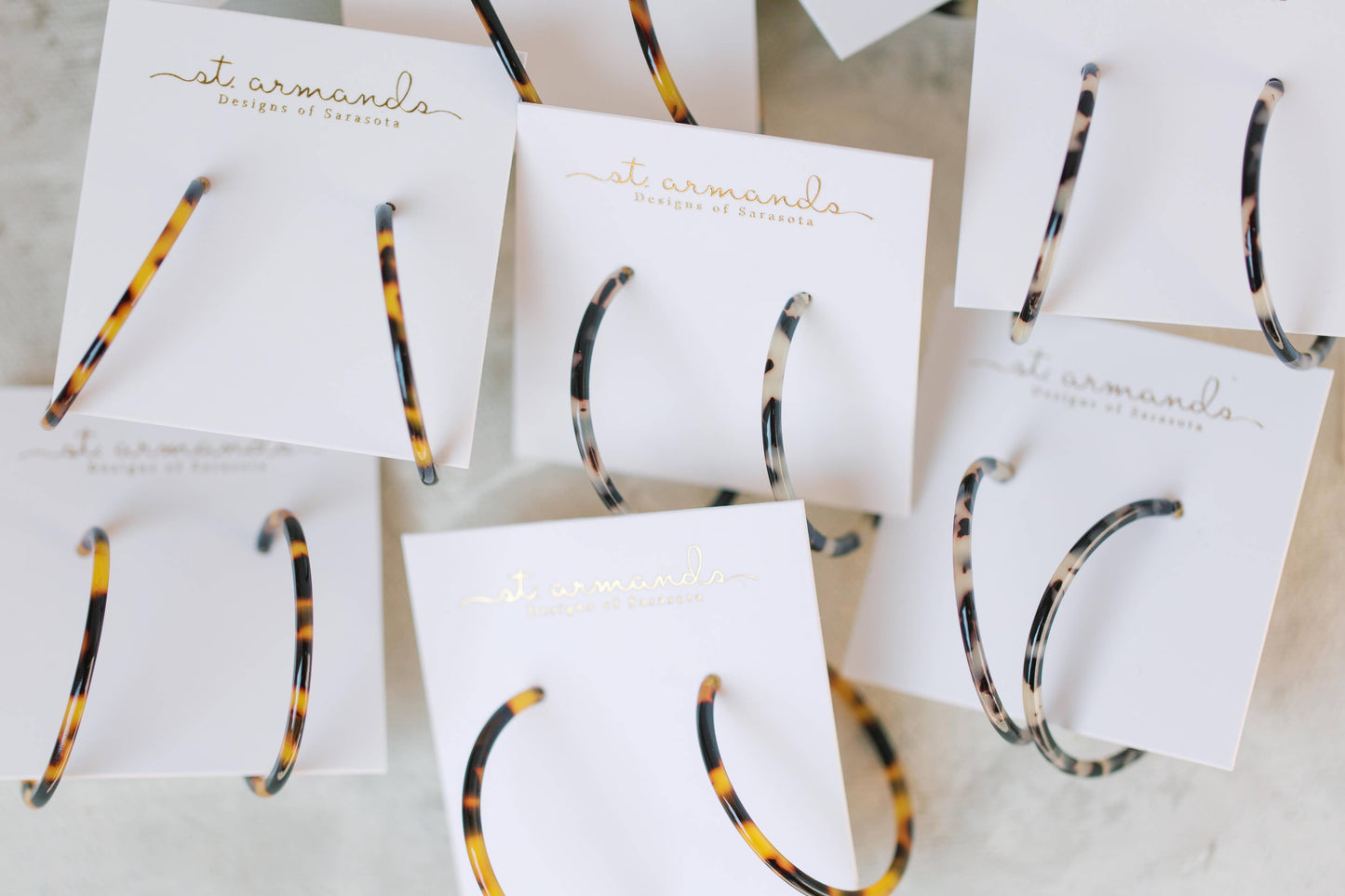 Skinny blonde tortoise hoop earrings by St Armands Designs of Sarasota, featuring lightweight, stylish tortoise pattern hoops.