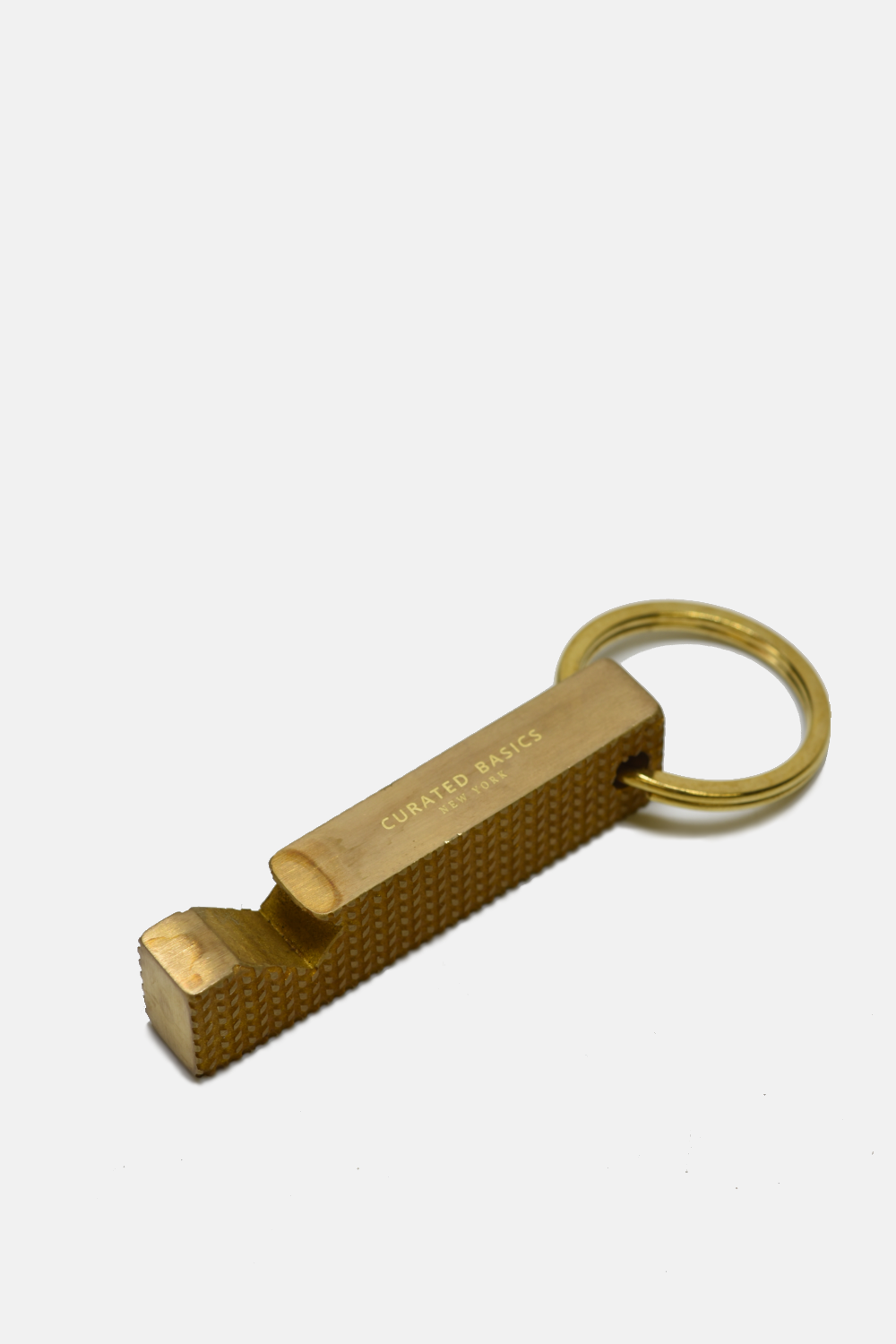 Brass bottle opener from Curated Basics with a sleek, polished design suitable for opening bottles at home or gatherings.
