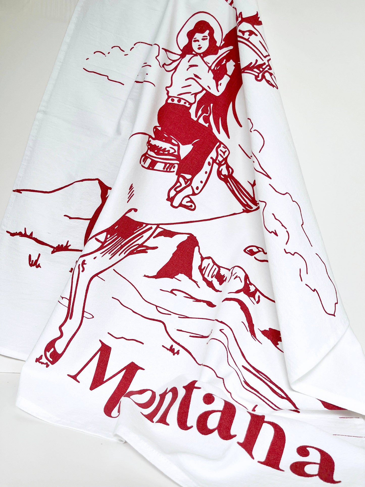 No Place Like Montana cowgirl kitchen towel from The Coin Laundry featuring a colorful Montana-themed design for kitchen decor.