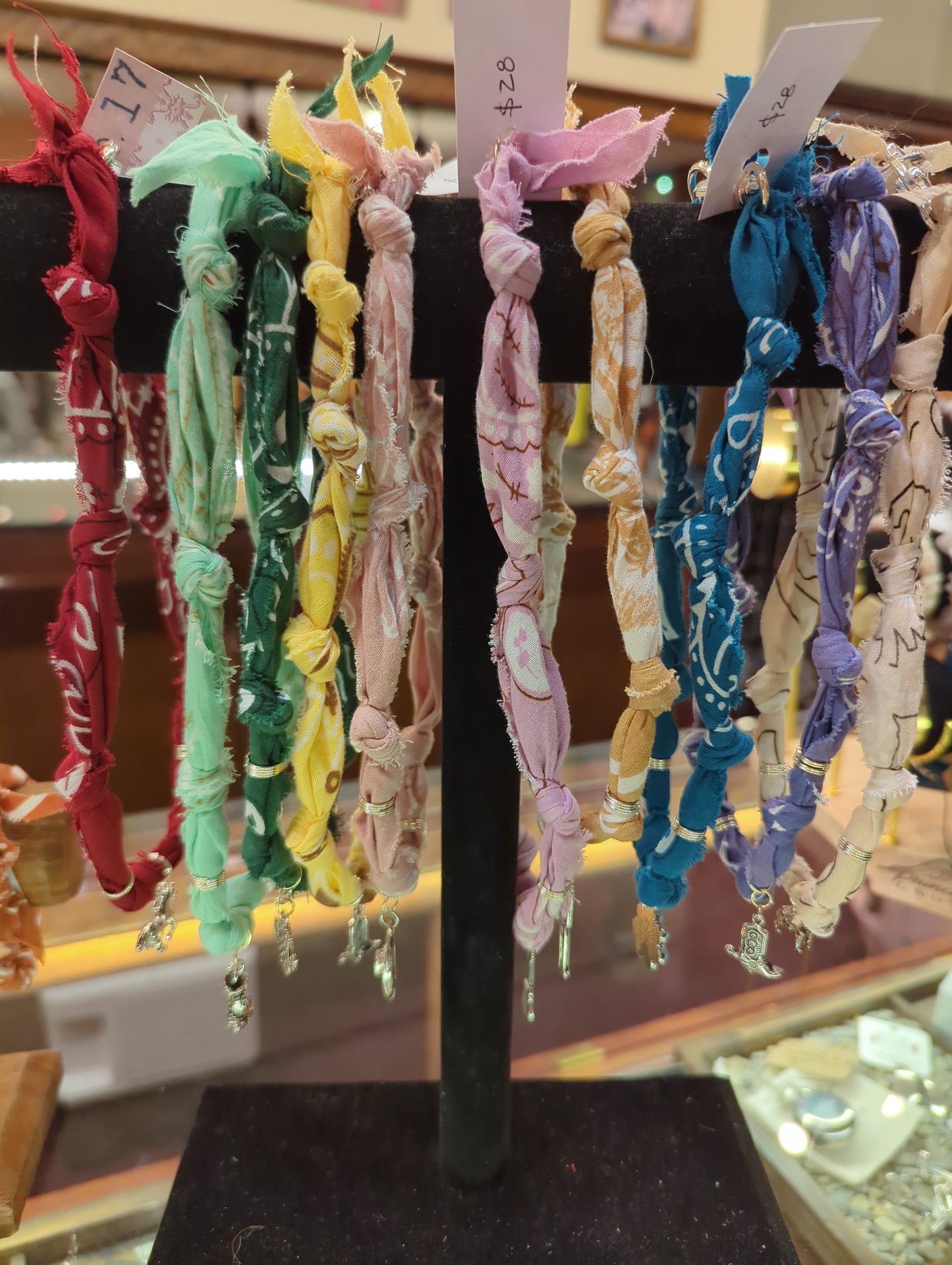 Wildwood Botanicals bandana charm necklace featuring a colorful fabric charm on a delicate chain.