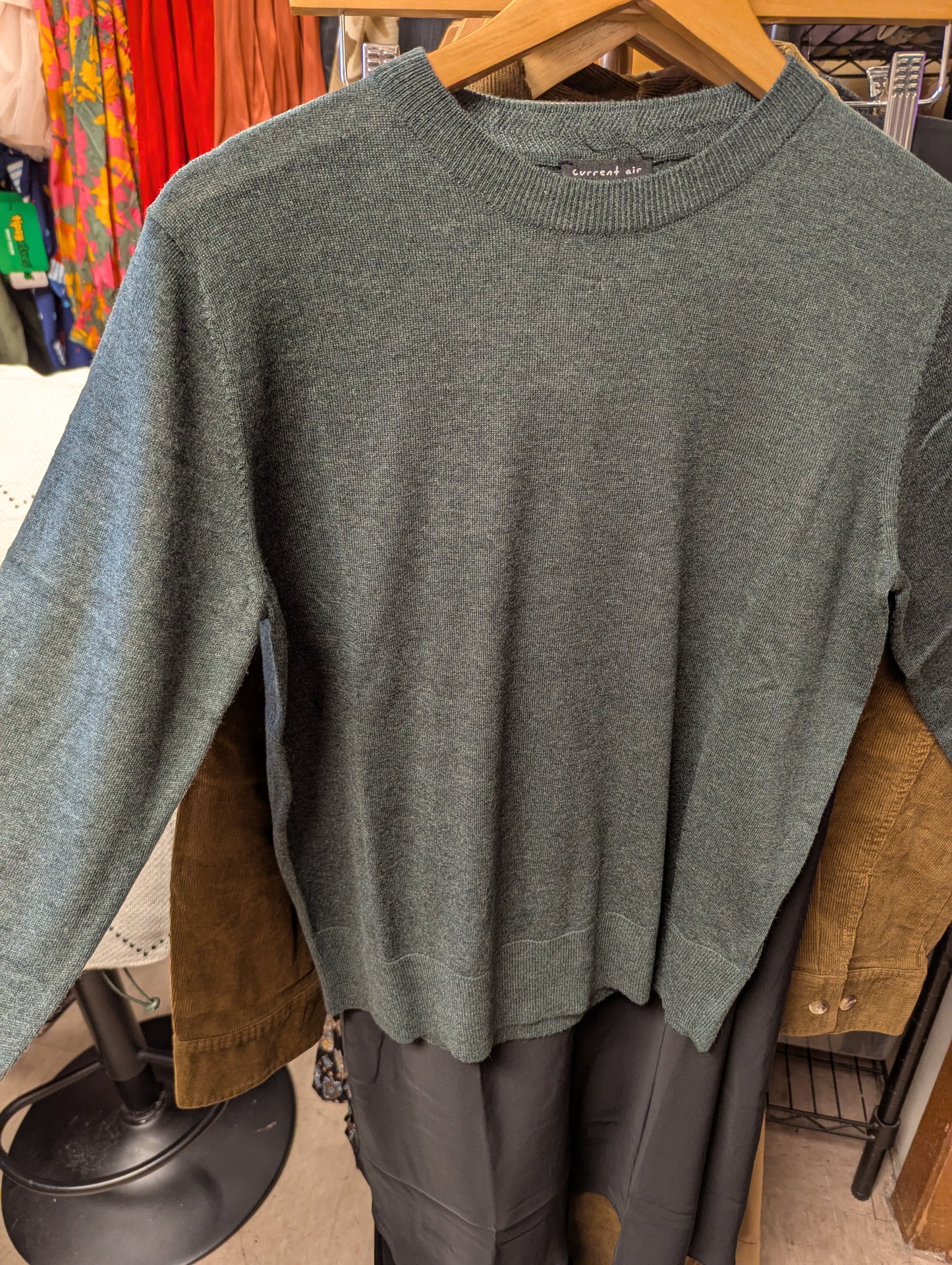 Moss green sweater from Current Air with a cozy knit texture, long sleeves, and a relaxed fit.