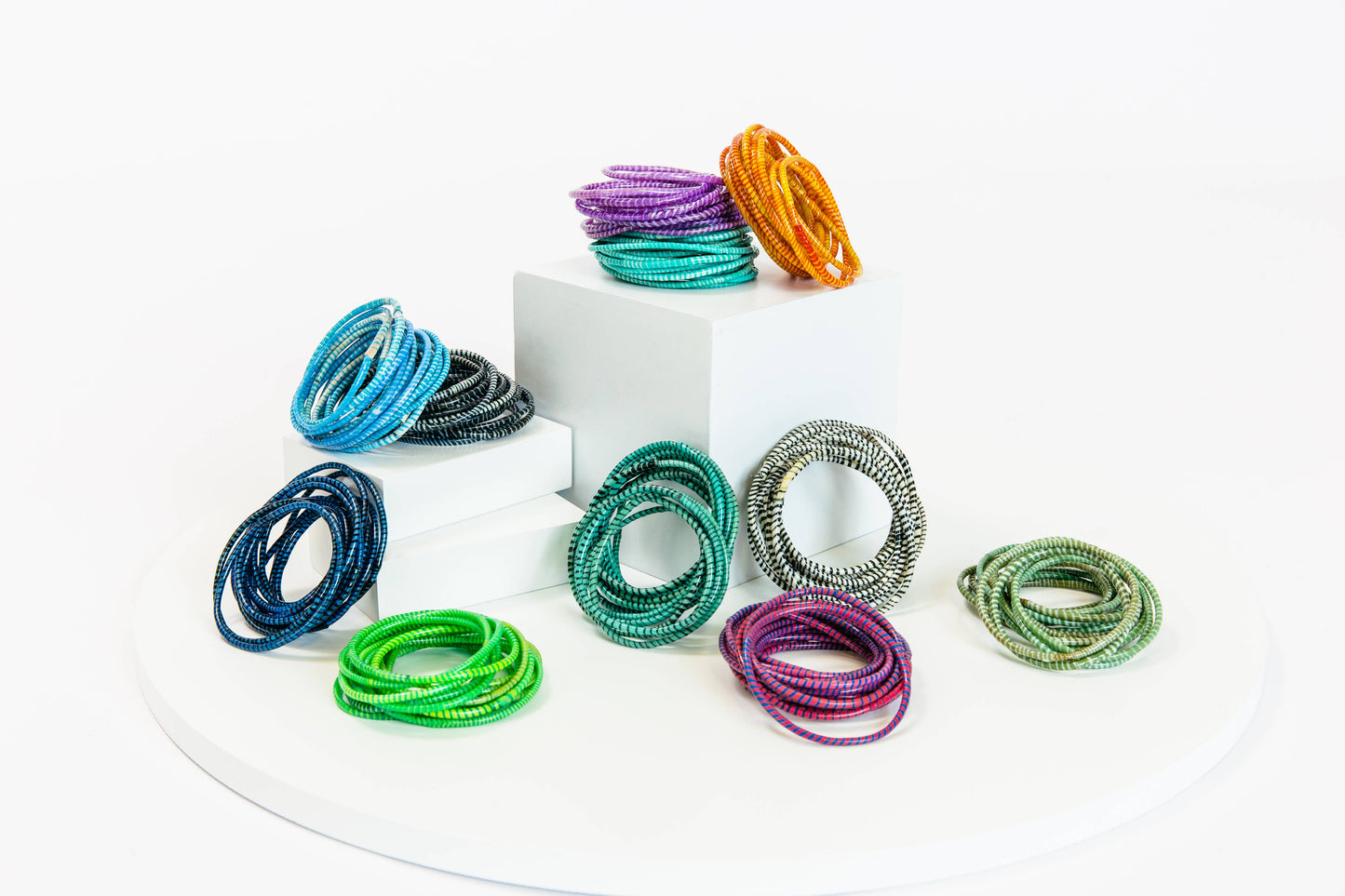 Shell pink Beach Bangles bracelet by BECASA featuring multiple colorful shell and beaded designs on a white background.