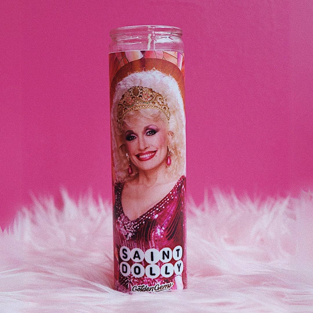Golden Gems Saint Dolly prayer candle with decorative religious imagery and a white wax finish.