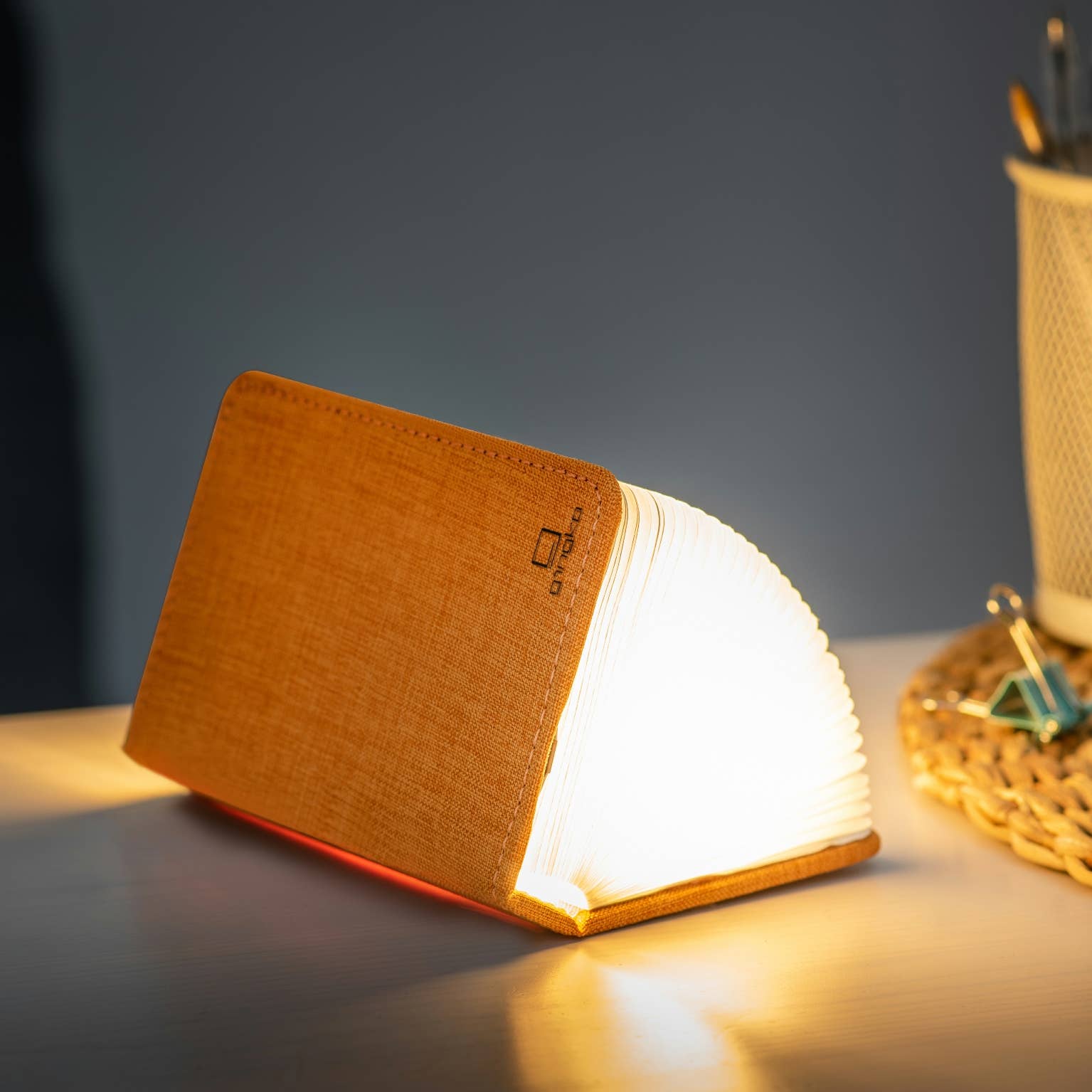 Gingko Design linen fabric smart book light lamp with soft glow, designed for reading and ambient lighting.