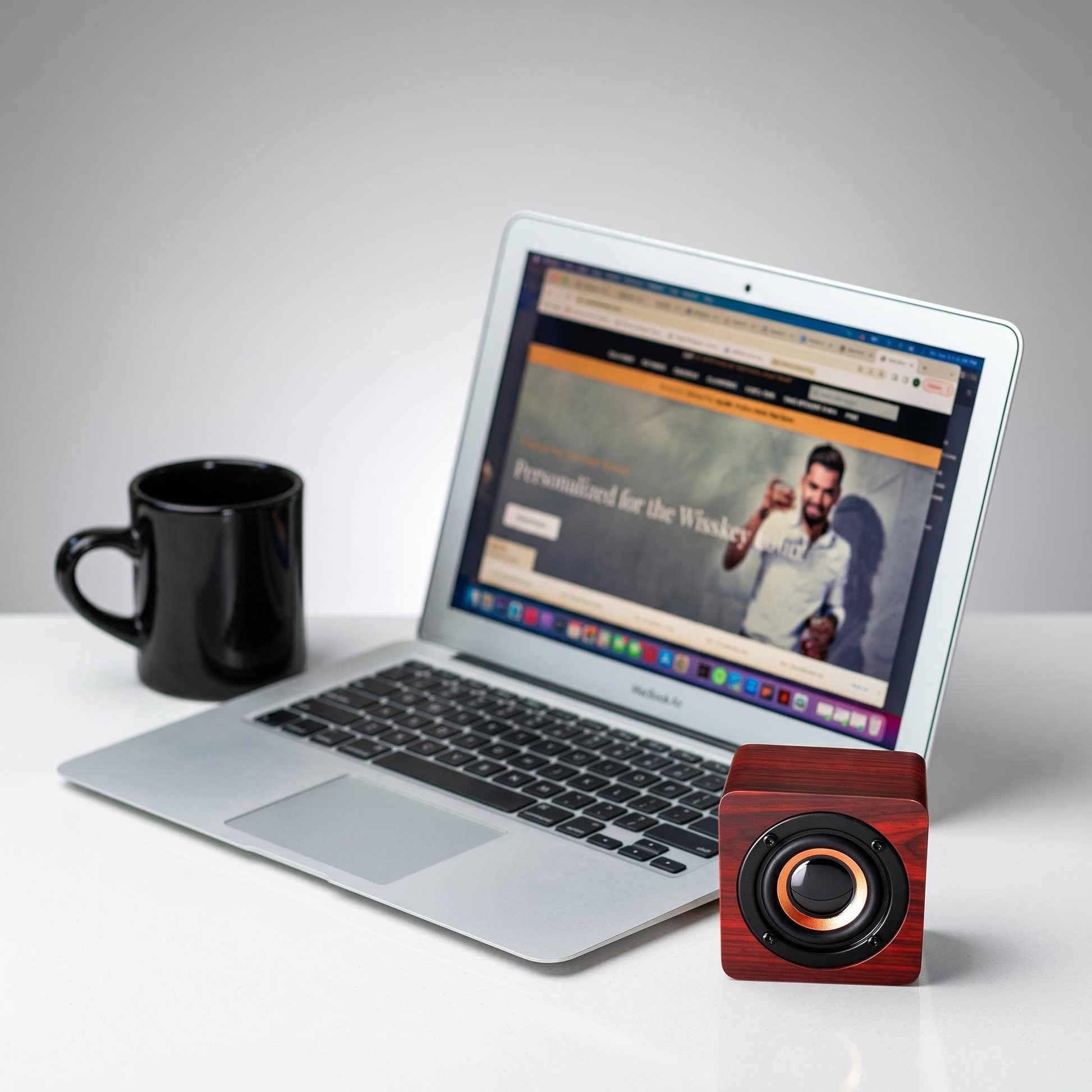 Cherrywood Bluetooth speaker by HomeWetBar with sleek design and control buttons visible on the front.