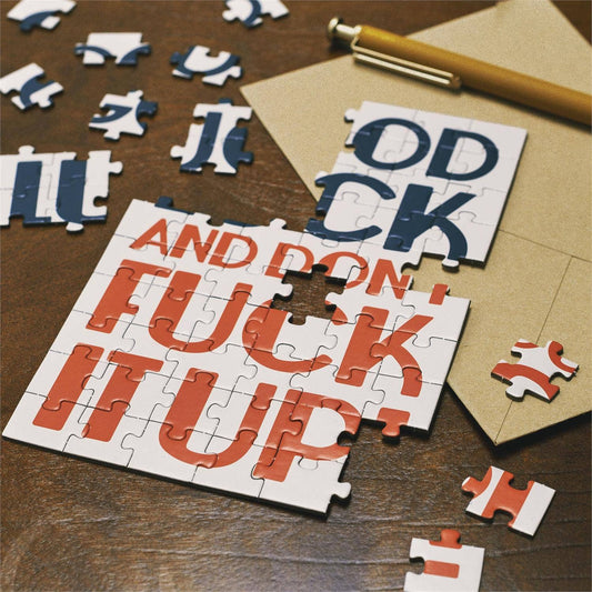 Questionables Good Luck Puzzle Card featuring a colorful, intricate puzzle design on a greeting card for good luck wishes.