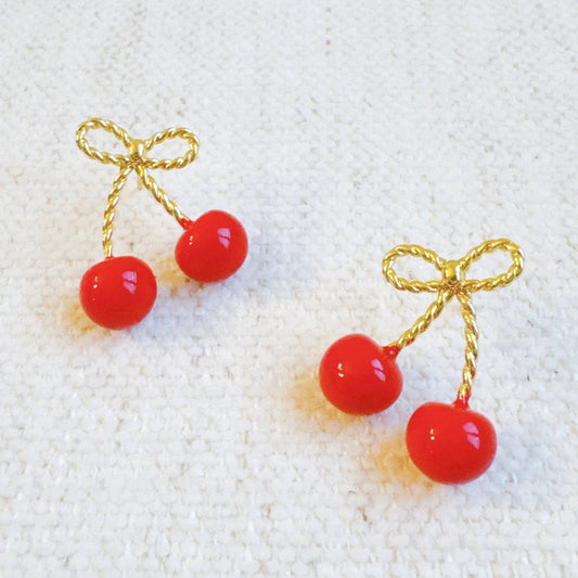 Ellison+Young bow and cherry earrings featuring gold-tone metal with red cherry accents and bow design for a playful accessory.