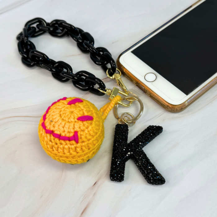 Ellison+Young phone wrist lanyard with adjustable strap and clip, designed for secure carrying of smartphones.