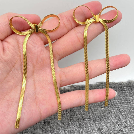 Mio Queena Chain Bow Earrings with delicate chain and bow design, stylish dangle earrings for women