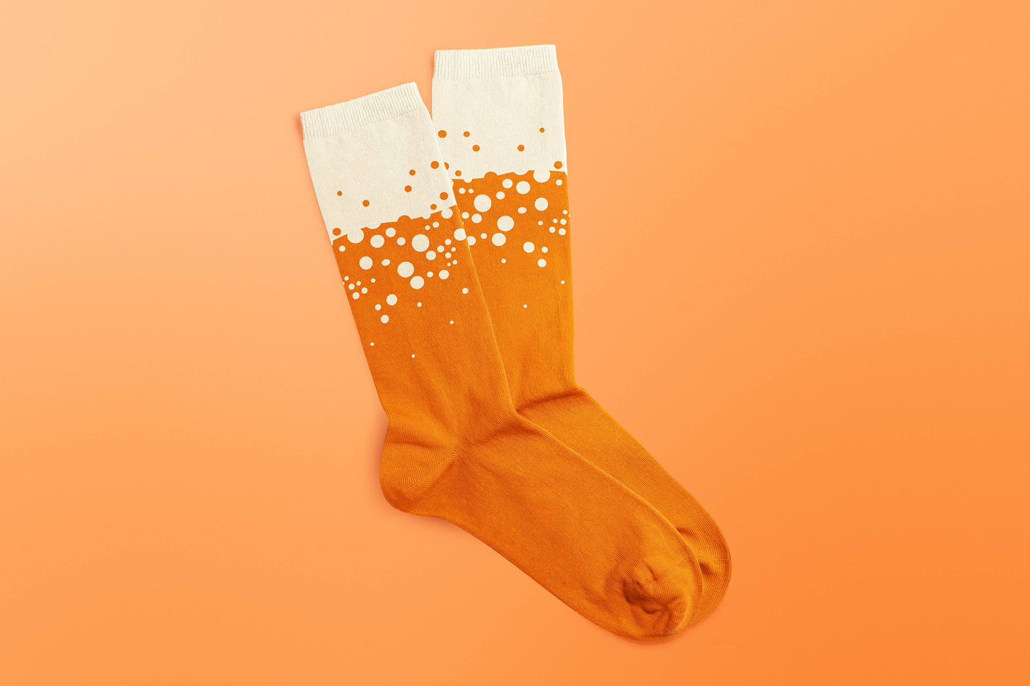 Pair of craft beer-themed socks by SUCK UK Ltd featuring colorful beer mug and hop patterns, casual socks for beer lovers.