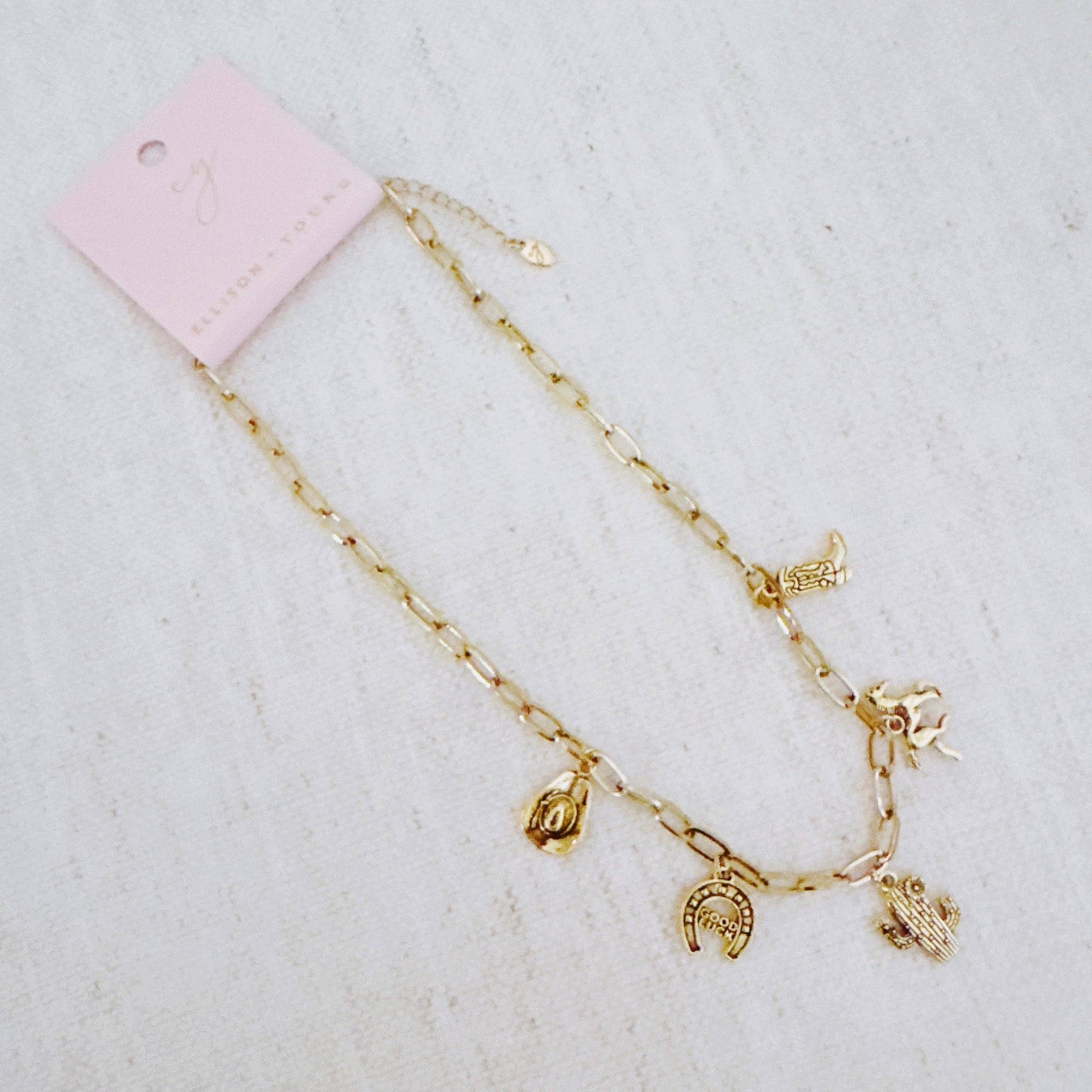 Western Cowgirl Charm Necklace by Ellison+Young featuring cactus, horseshoe, and boot charms on a silver chain.