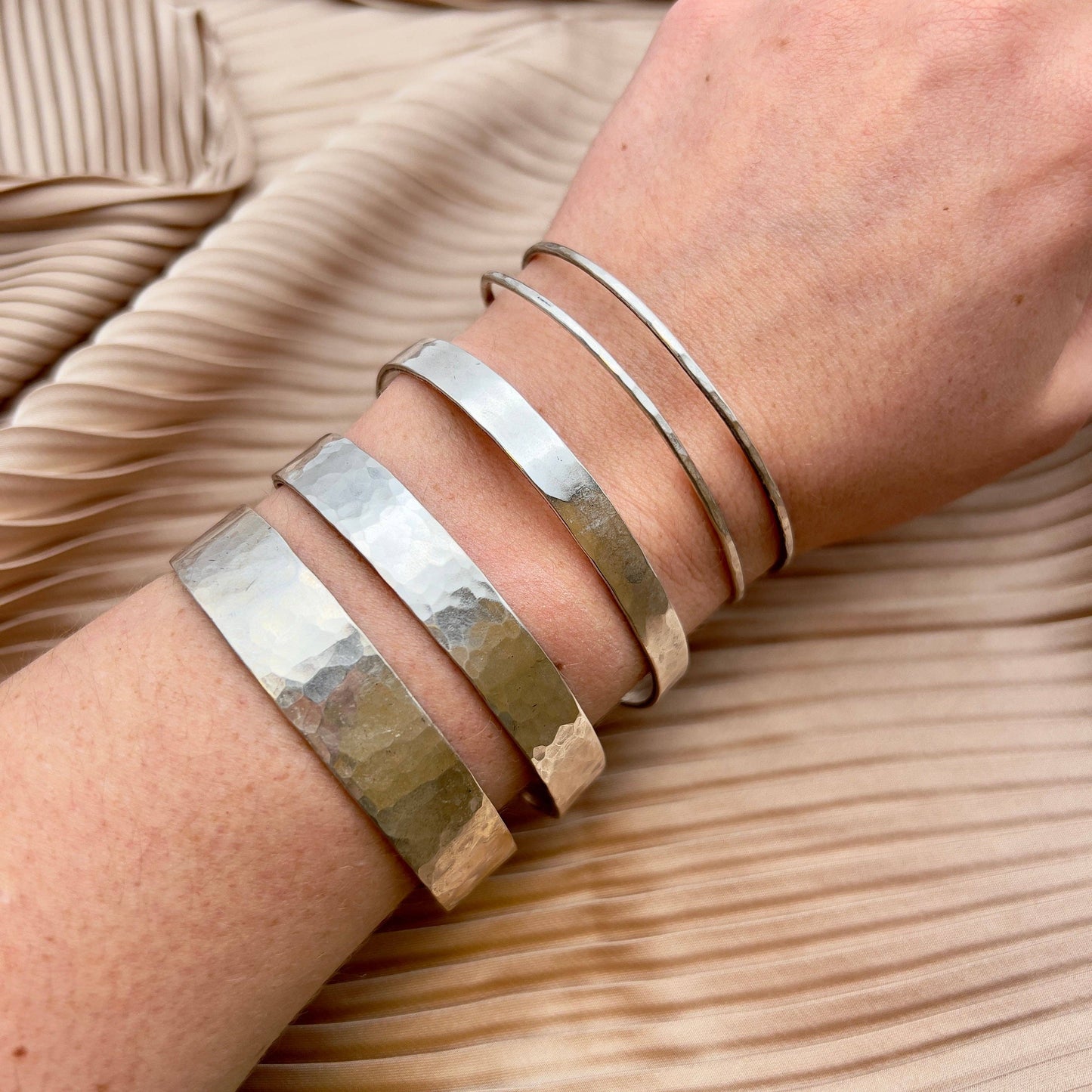 Handmade She-Ra themed bracelet cuffs by Fluff Hardware featuring intricate designs and metallic finishes.