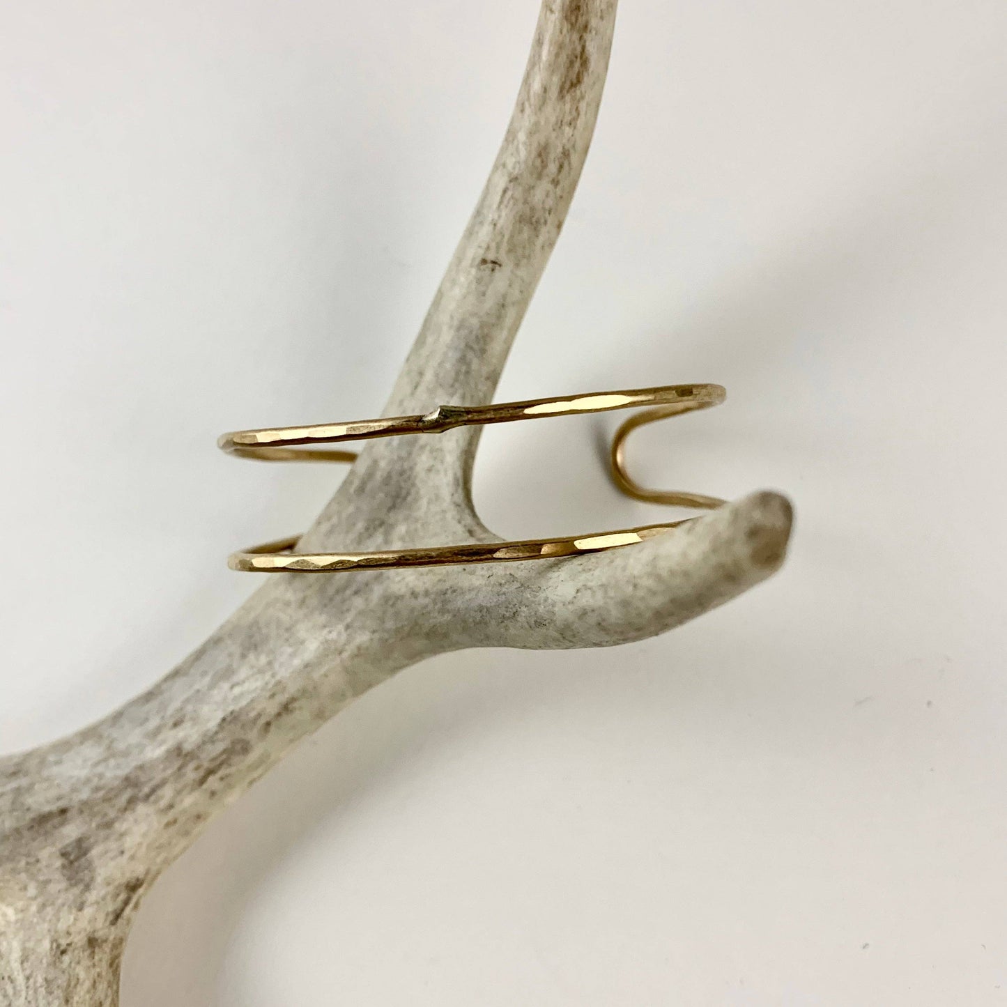 Handmade She-Ra style cuff bracelet by Fluff Hardware featuring intricate designs on metal cuffs.
