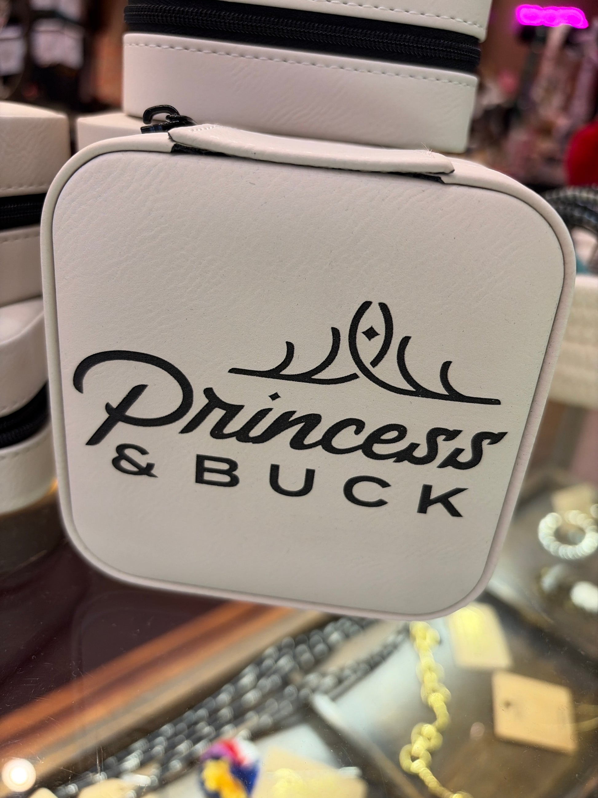 Leatherette jewelry box by Princess & Buck, open view showing compartments for rings, earrings, and necklaces.