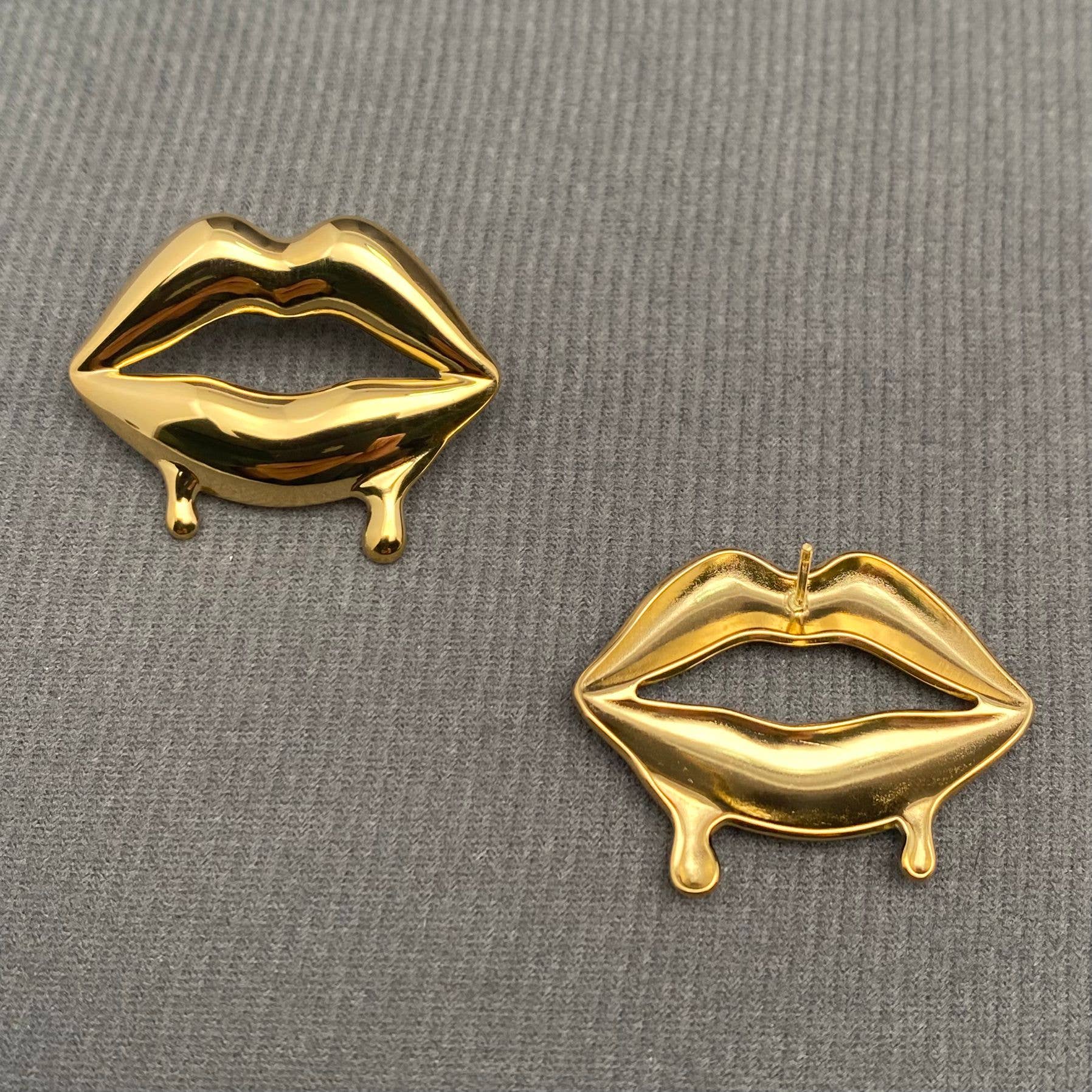 Glossy Lips earrings by Mio Queena featuring shiny, lip-shaped earrings with a glossy finish, styled on a model's ears.