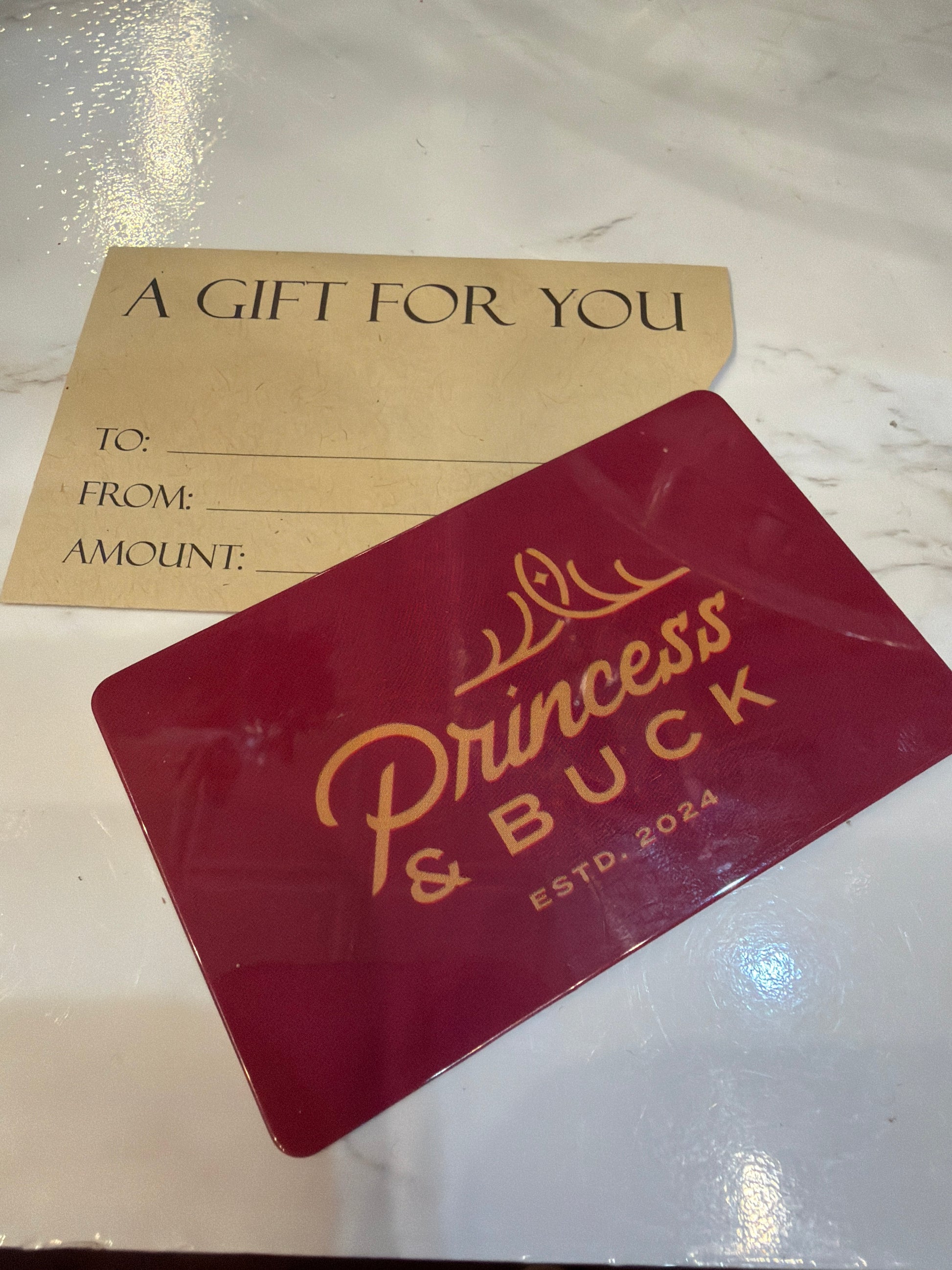 Princess & Buck gift card featuring elegant design and brand logo, perfect for gifting and special occasions.