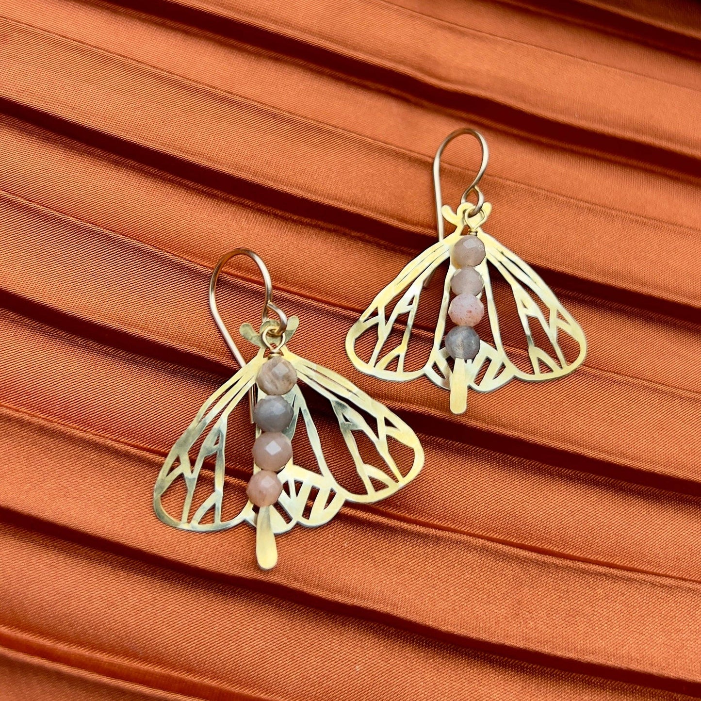 Handmade Peppered Moth earrings by Fluff Hardware showing detailed black and white moth design on silver hooks.
