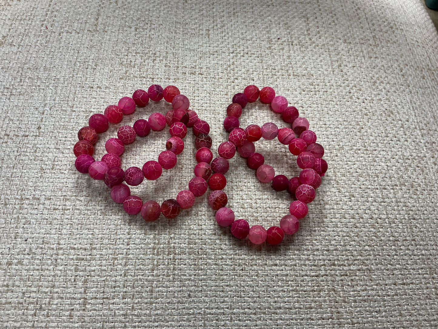 Pink glass beaded bracelet with round beads, stylish jewelry accessory from American Unique Group.