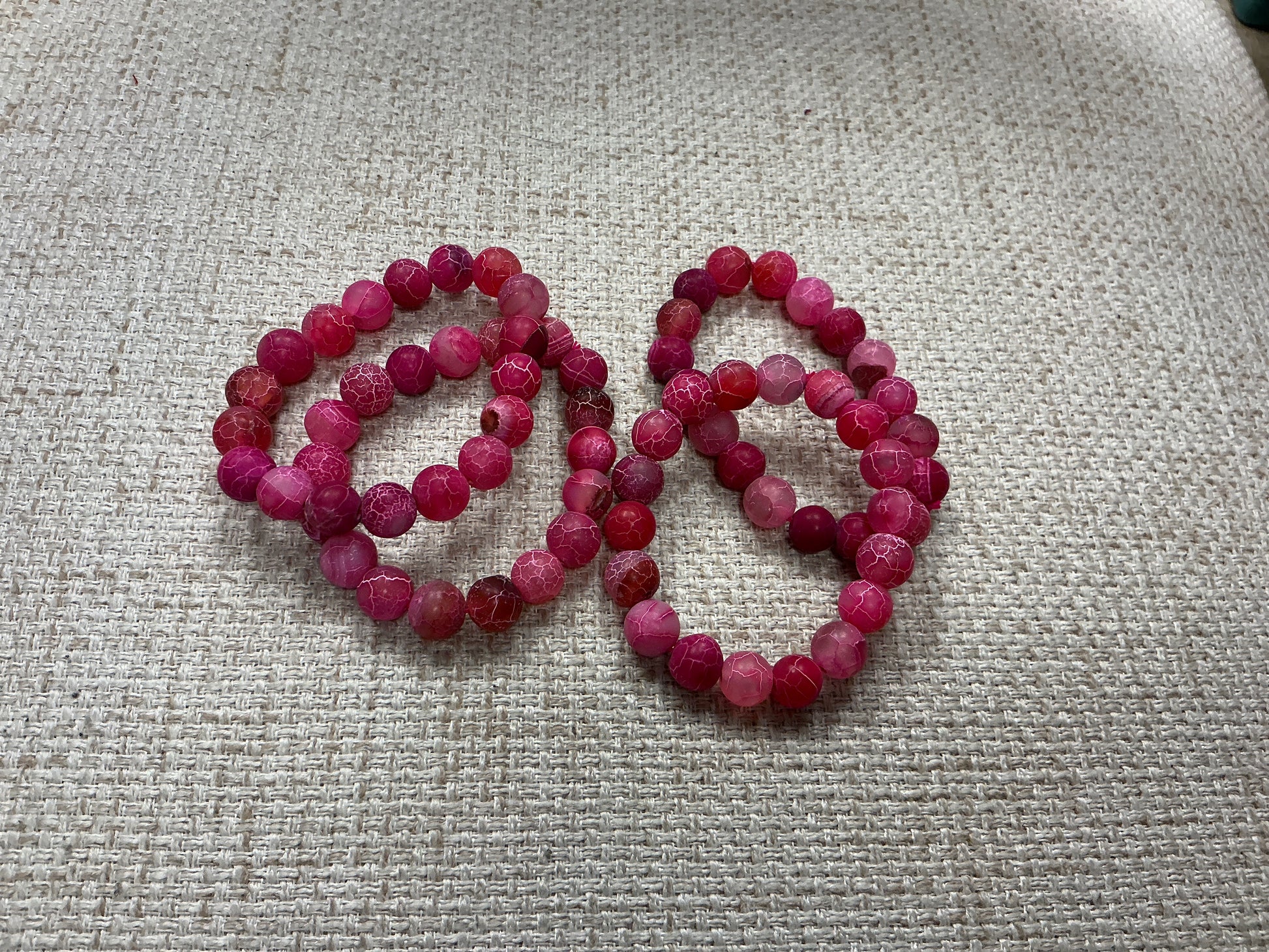 Pink glass beaded bracelet with round beads, stylish jewelry accessory from American Unique Group.