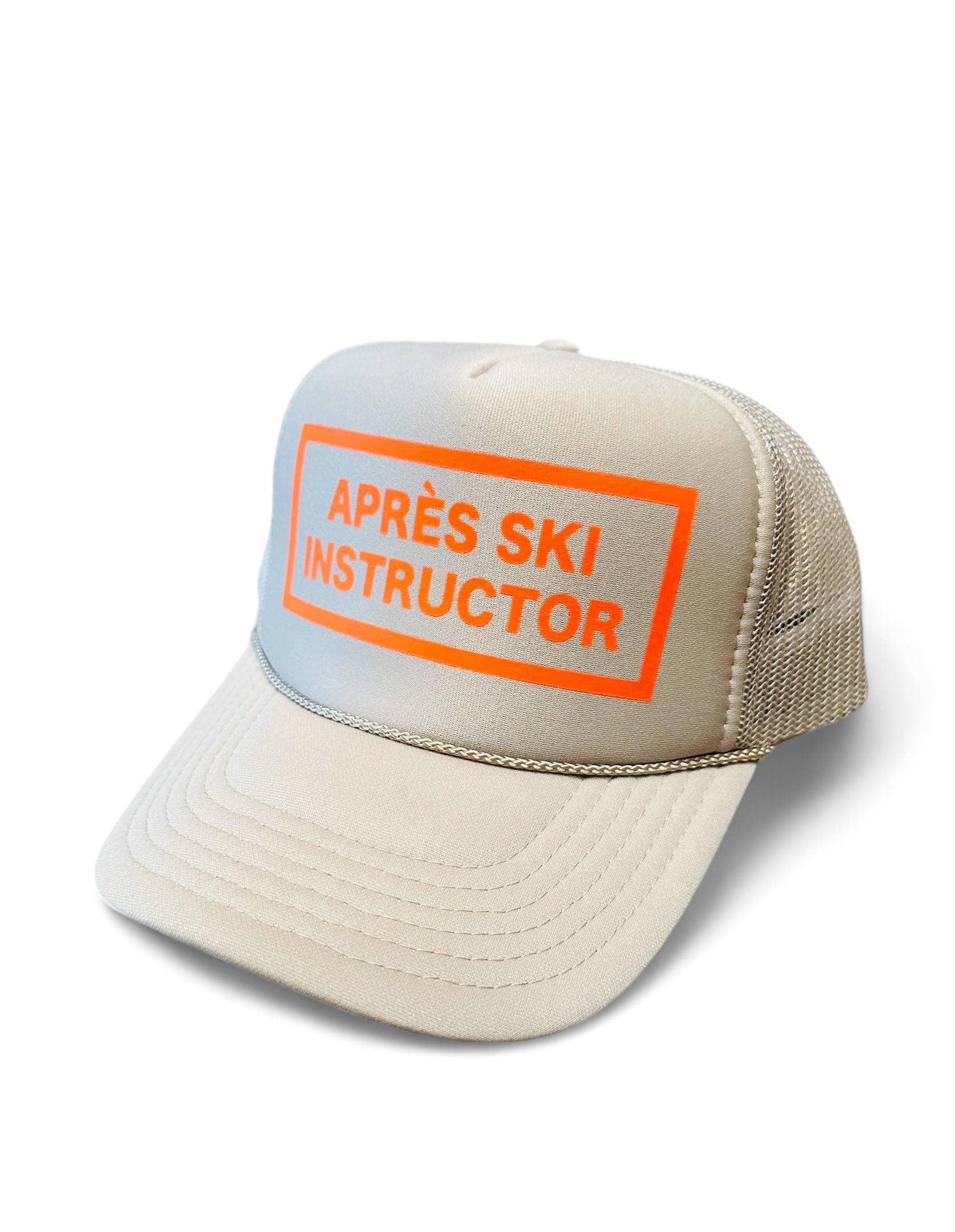 Après Babe Après Ski Instructor Trucker Hat with embroidered patch, mesh back, and adjustable snap closure.