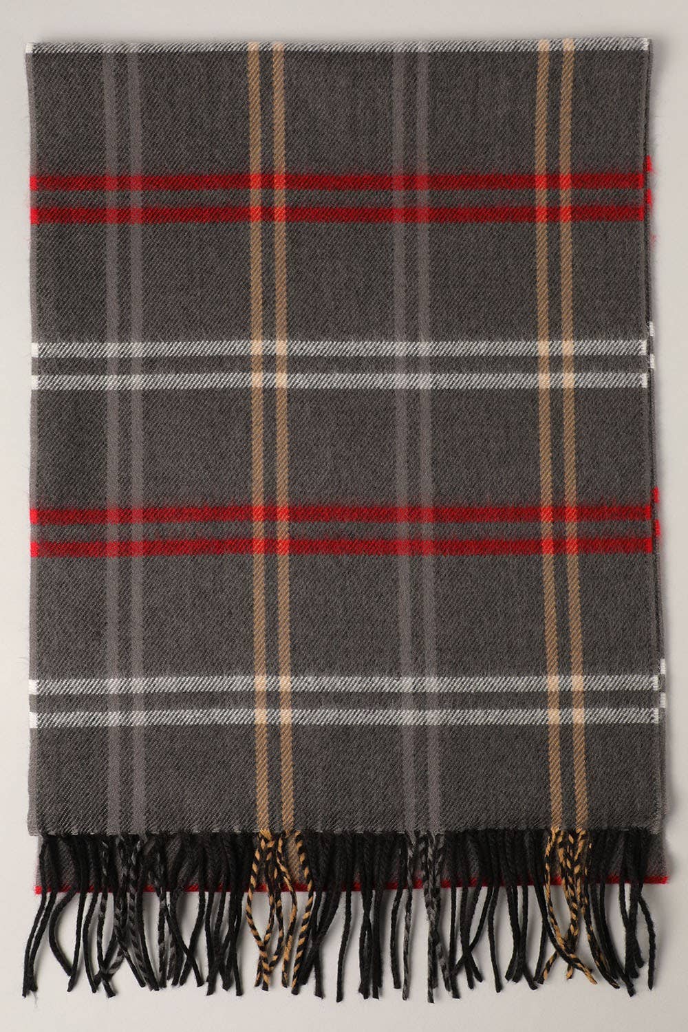 Fashion City tartan plaid muffler scarf draped over a neutral background, showcasing its vibrant red and black plaid pattern.