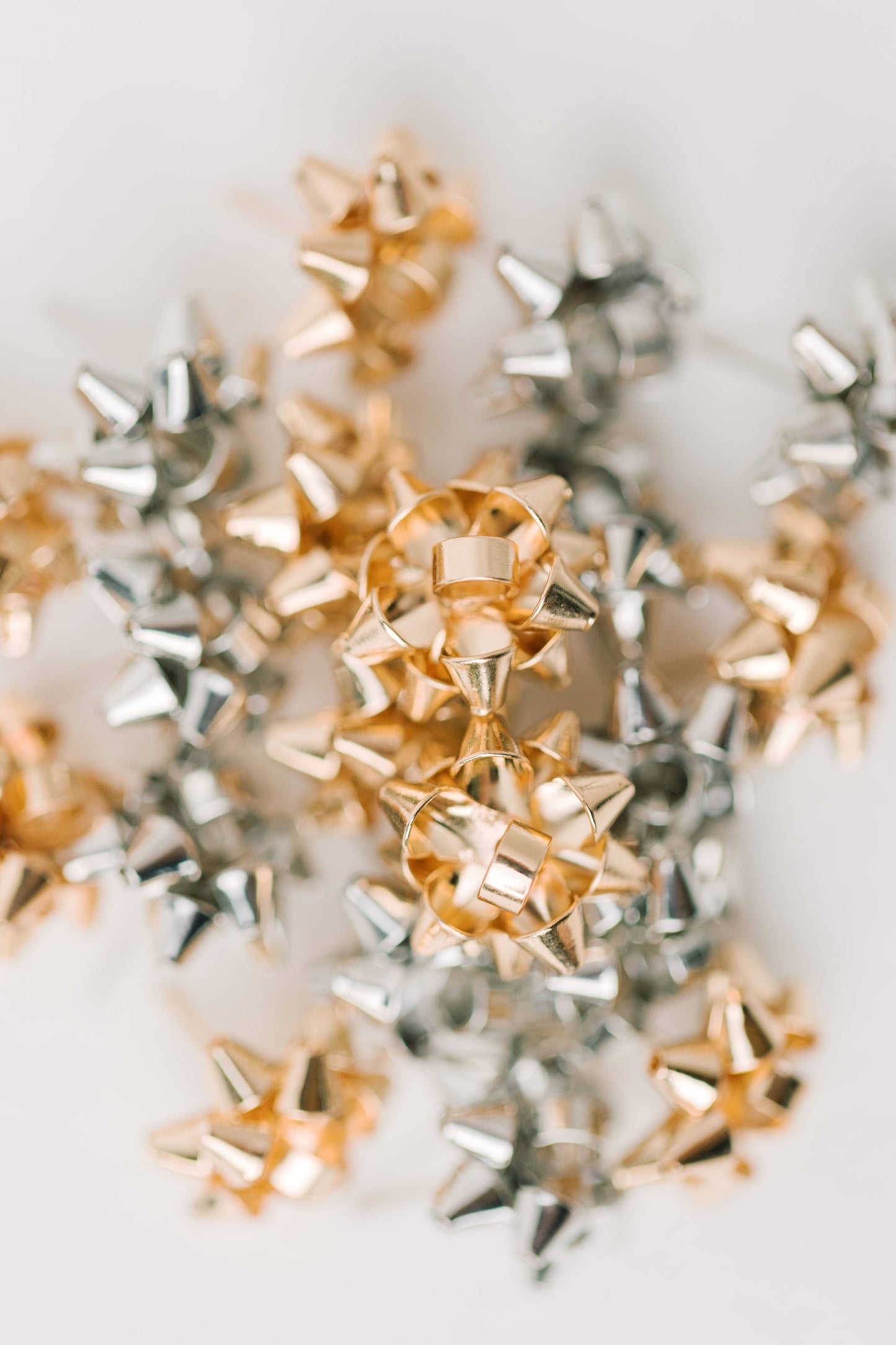 Gold Present Bow Earrings by St Armands Designs of Sarasota featuring festive gift bow-shaped jewelry with polished gold finish.