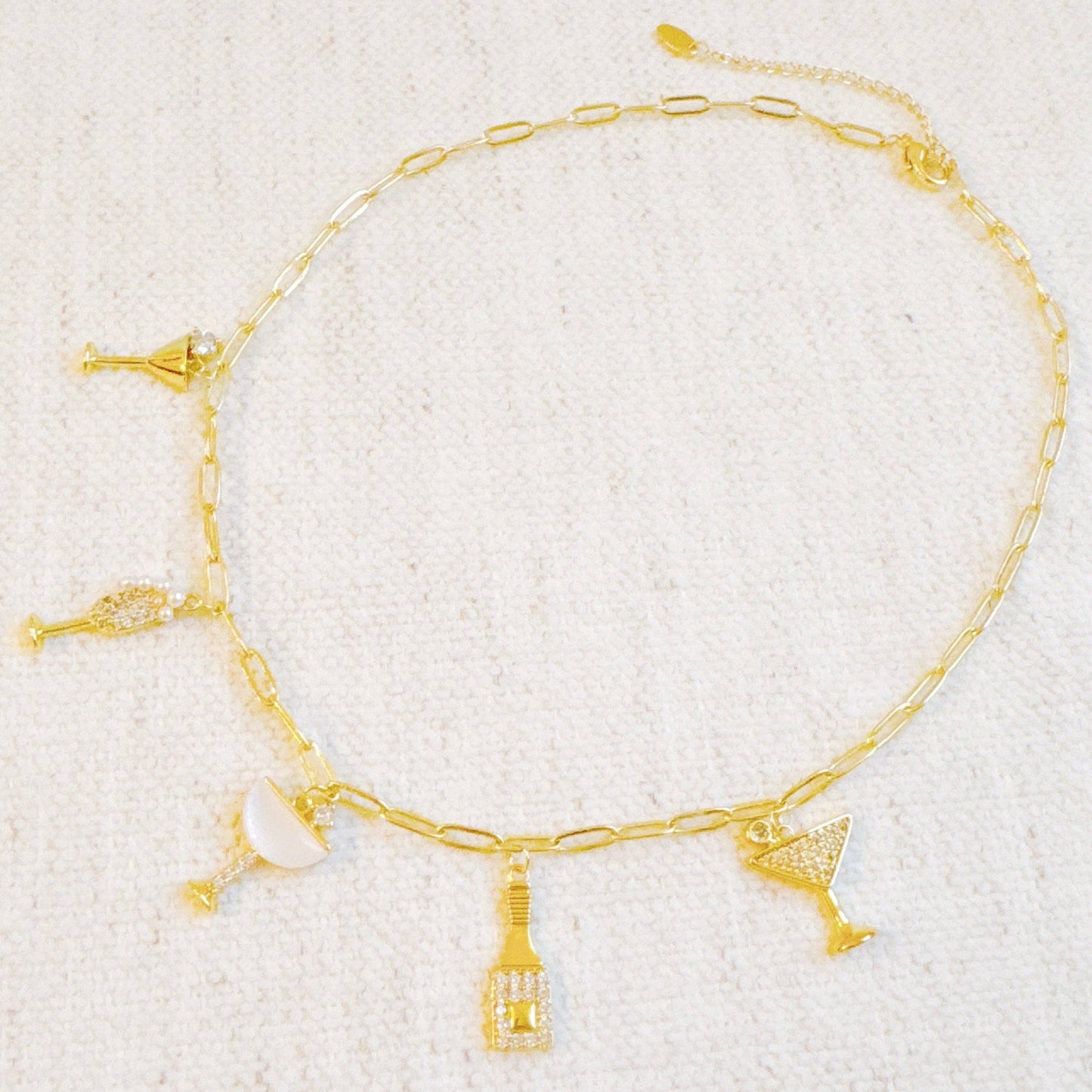 Ellison+Young Cheers To Happiness multi charm necklace with colorful charms on a silver chain.