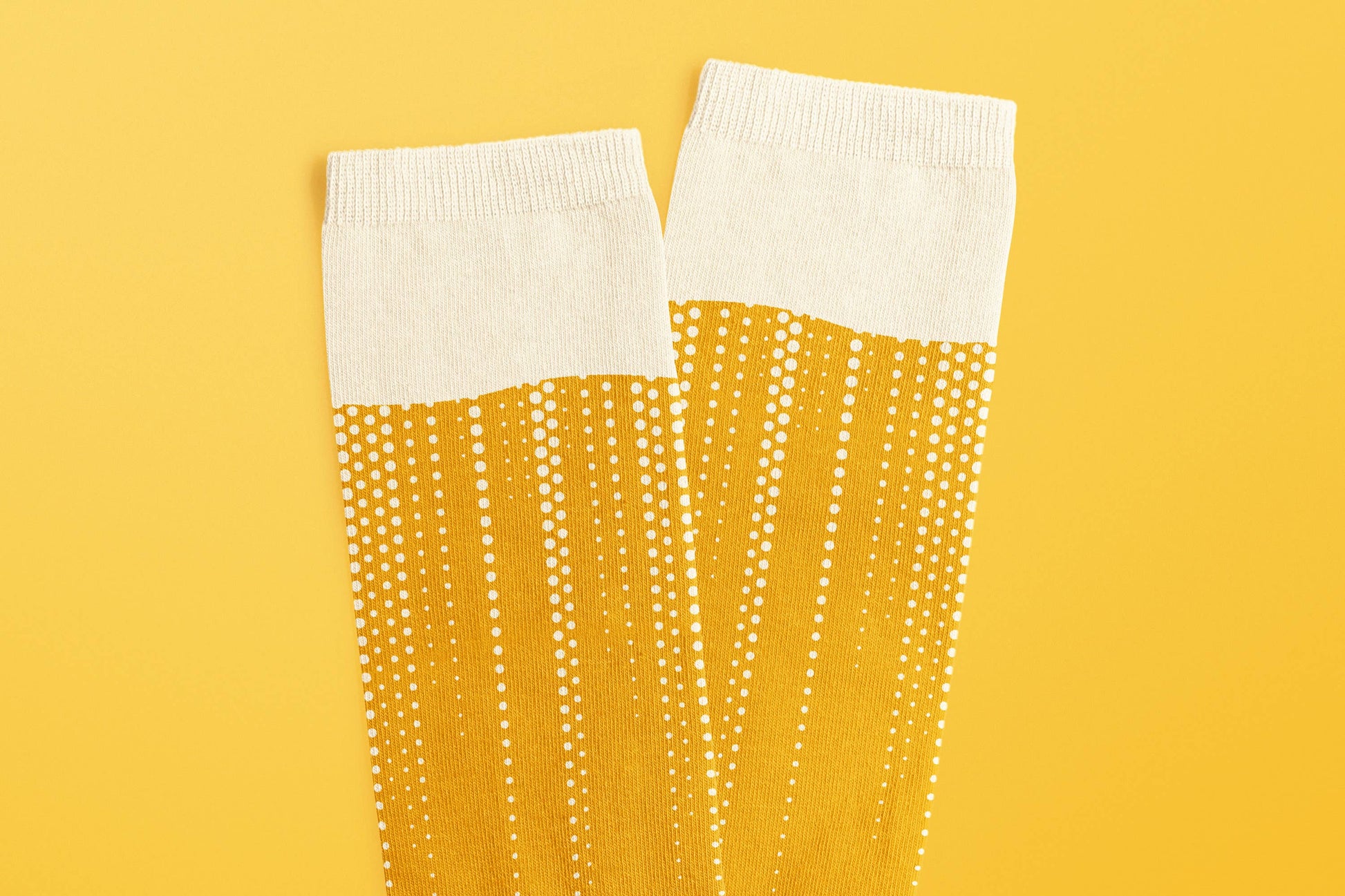 Pair of colorful Craft Beer Socks by SUCK UK Ltd - USA featuring beer mug and hop patterns on comfortable knit fabric.