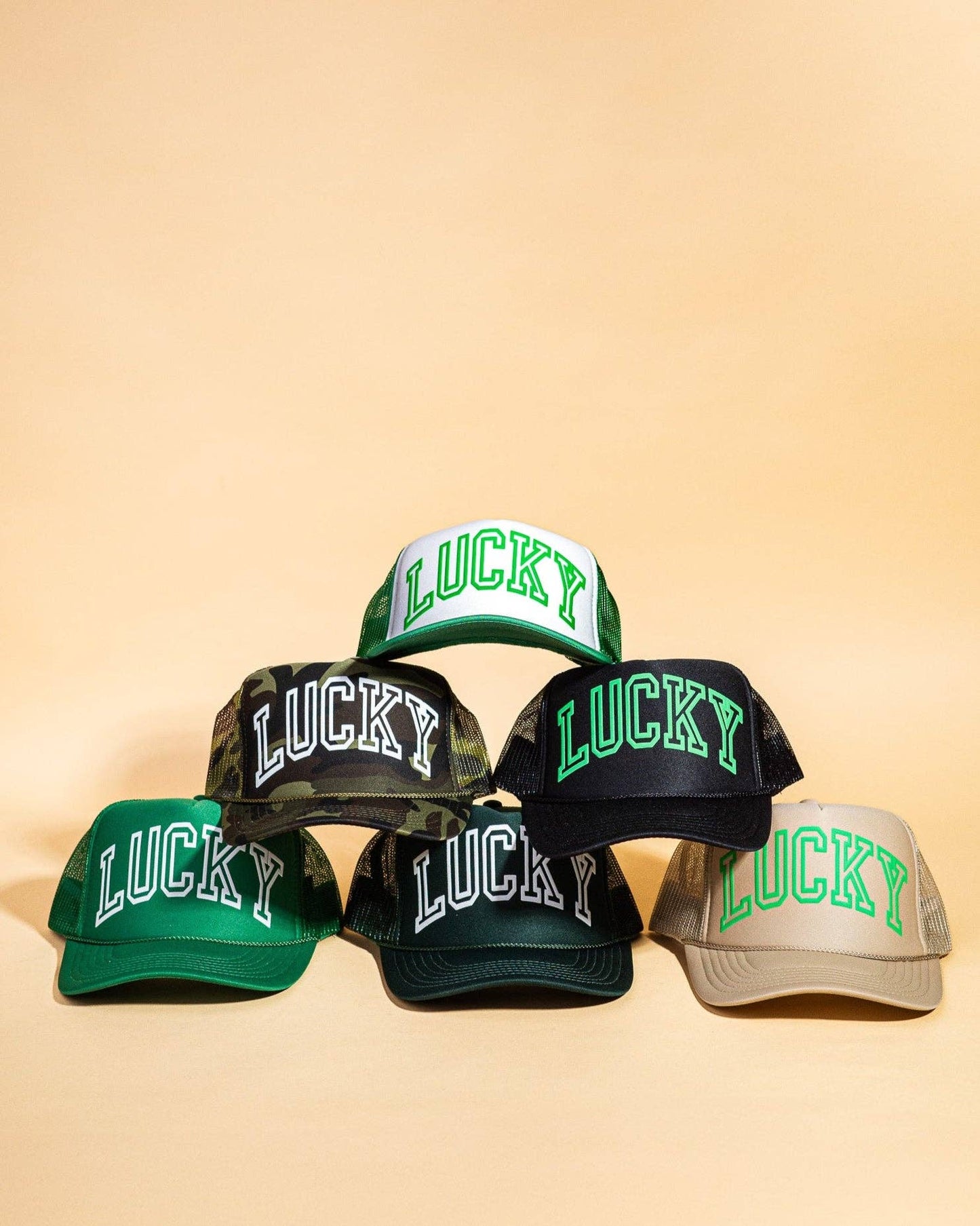 Ascot + Hart Lucky Trucker hat, casual baseball style cap with embroidered logo and adjustable strap, in neutral tones.