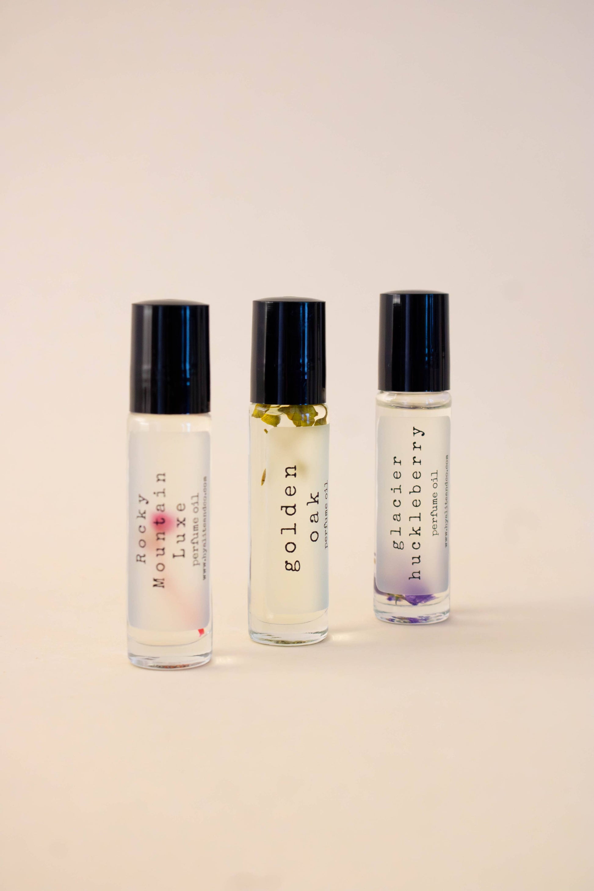 Hyalite & Co roll-on perfume oil with a clear glass bottle and black cap, showcasing the elegant packaging of the perfume product.