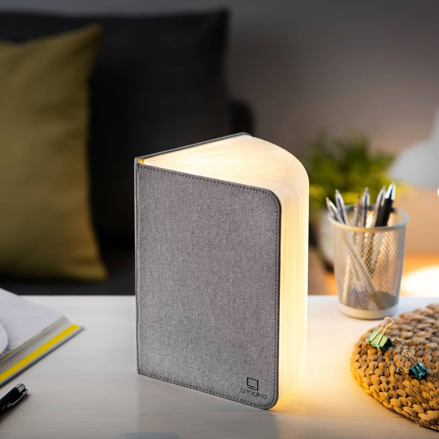 Gingko Design linen fabric smart book light with adjustable lamp arm and warm LED illumination, ideal for reading in bed