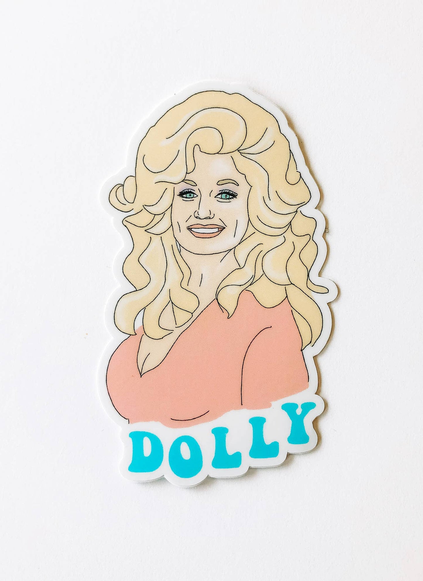 Colorful Dolly vinyl sticker from Maddon and Co featuring a playful cartoon doll design on a white background.
