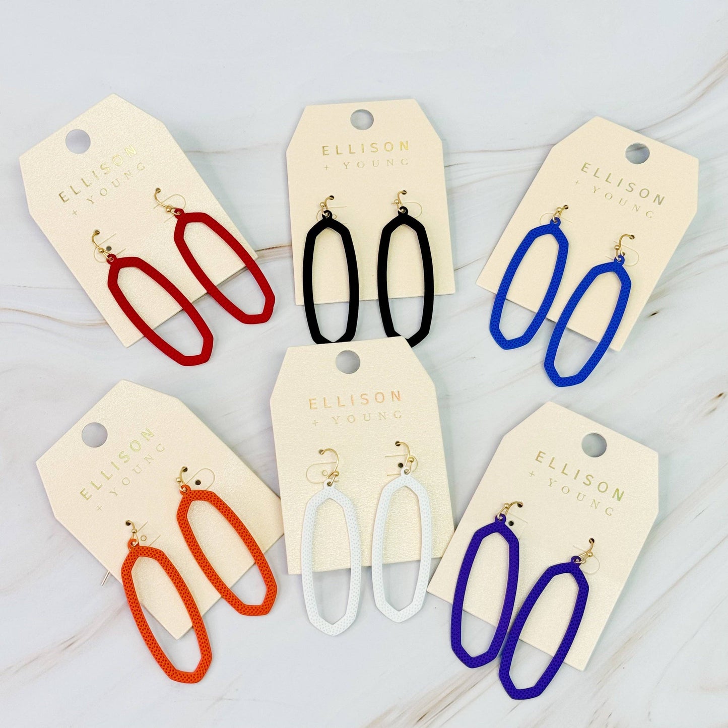 Ellison+Young Shape Of Game earrings featuring modern geometric design on silver hooks, close-up view.