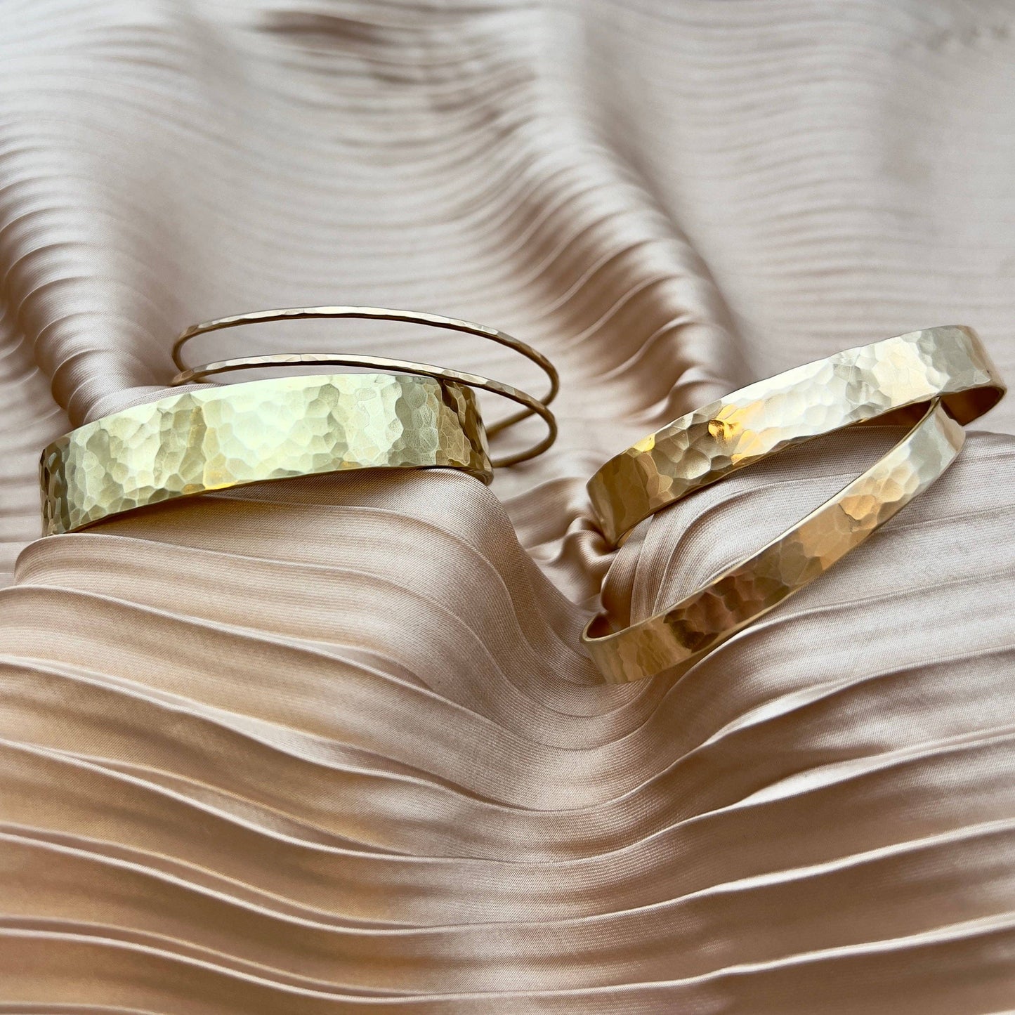 Handmade She-Ra themed bracelet cuffs by Fluff Hardware, featuring intricate designs and metal craftsmanship.