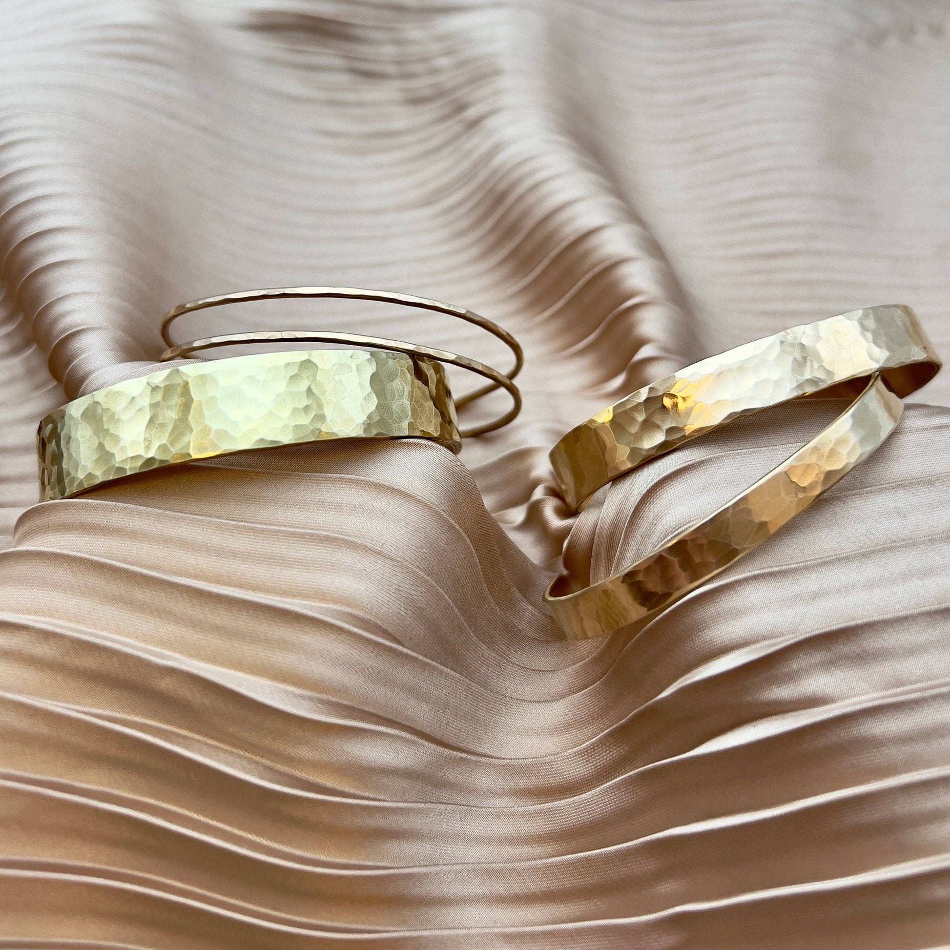 Handmade She-Ra themed bracelet cuffs by Fluff Hardware, featuring intricate designs and metal craftsmanship.
