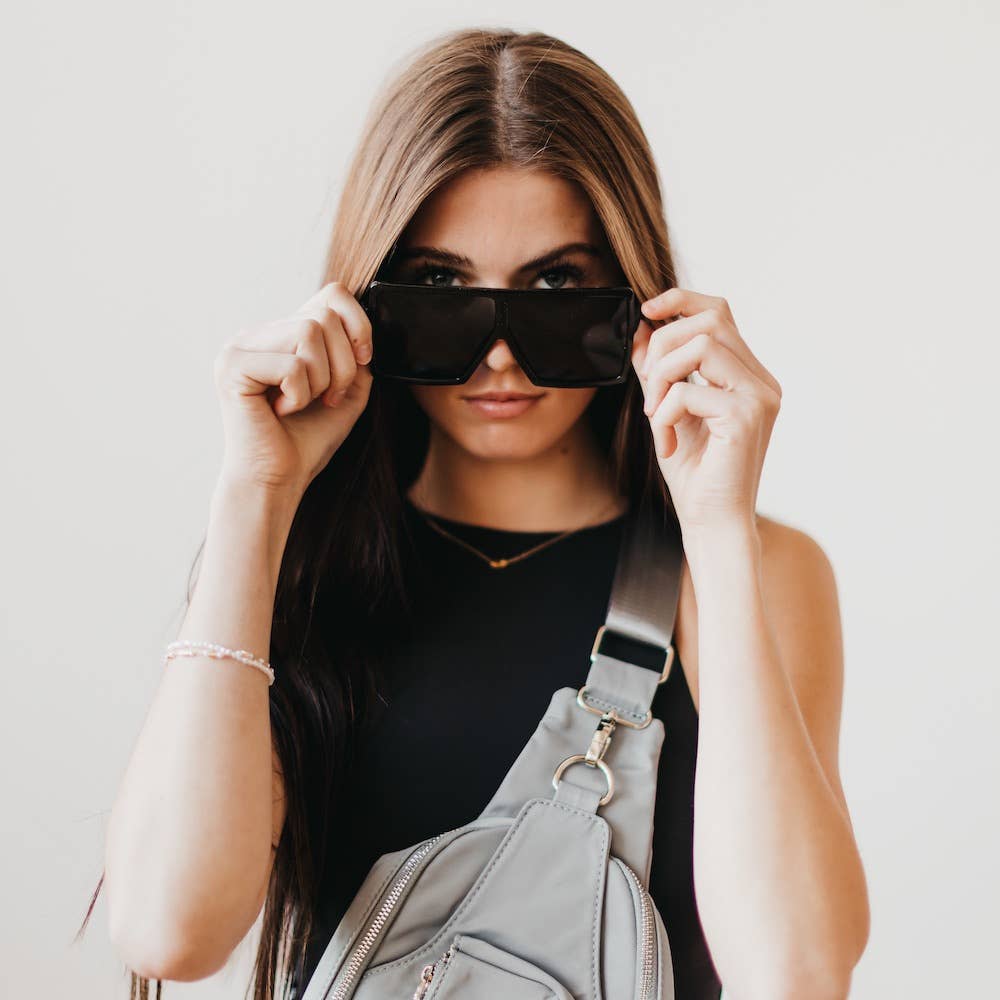 Pretty Simple Beverly oversized sunglasses with dark tinted lenses and bold black frames on a white background.