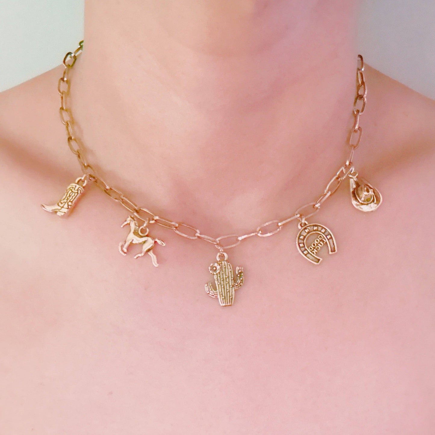 Western Cowgirl Charm Necklace by Ellison+Young featuring cactus, horseshoe, and boot charms on a chain.