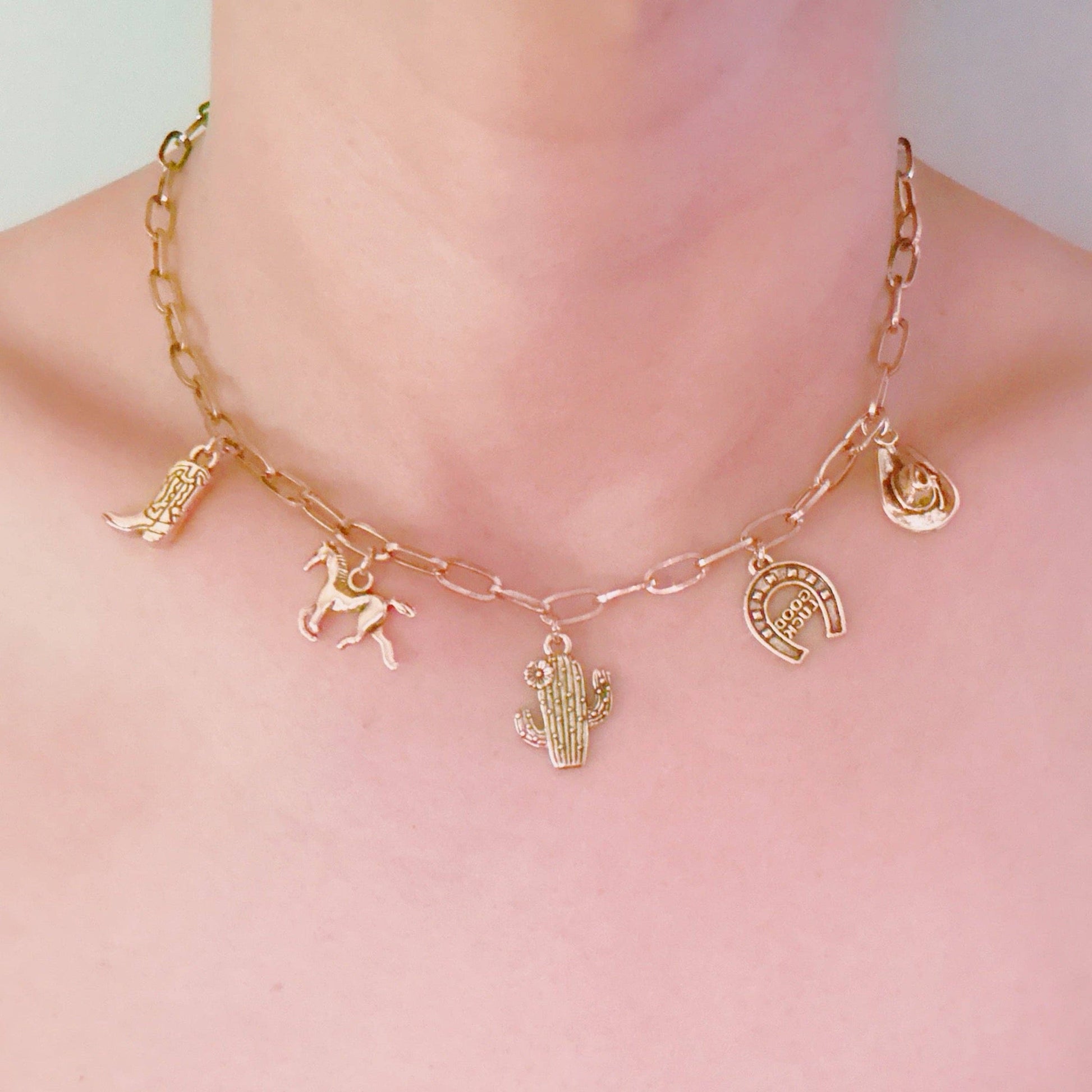 Western Cowgirl Charm Necklace by Ellison+Young featuring cactus, horseshoe, and boot charms on a chain.