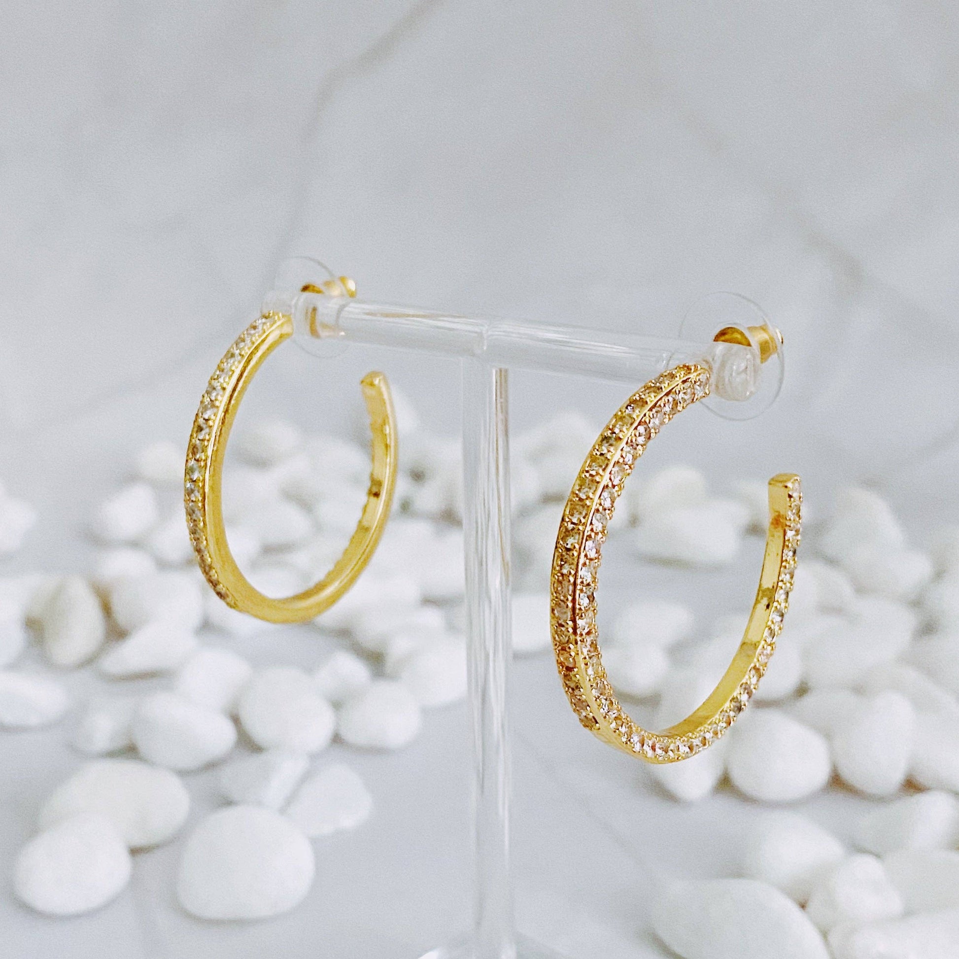 Reversible hoop earrings by Ellison+Young featuring plain and shine finishes, shown in a close-up image of the stylish jewelry.
