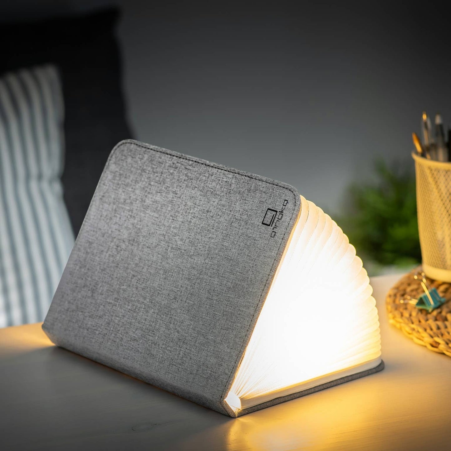 Gingko Design linen fabric smart book light lamp with soft LED illumination, compact and stylish for reading or bedside use.