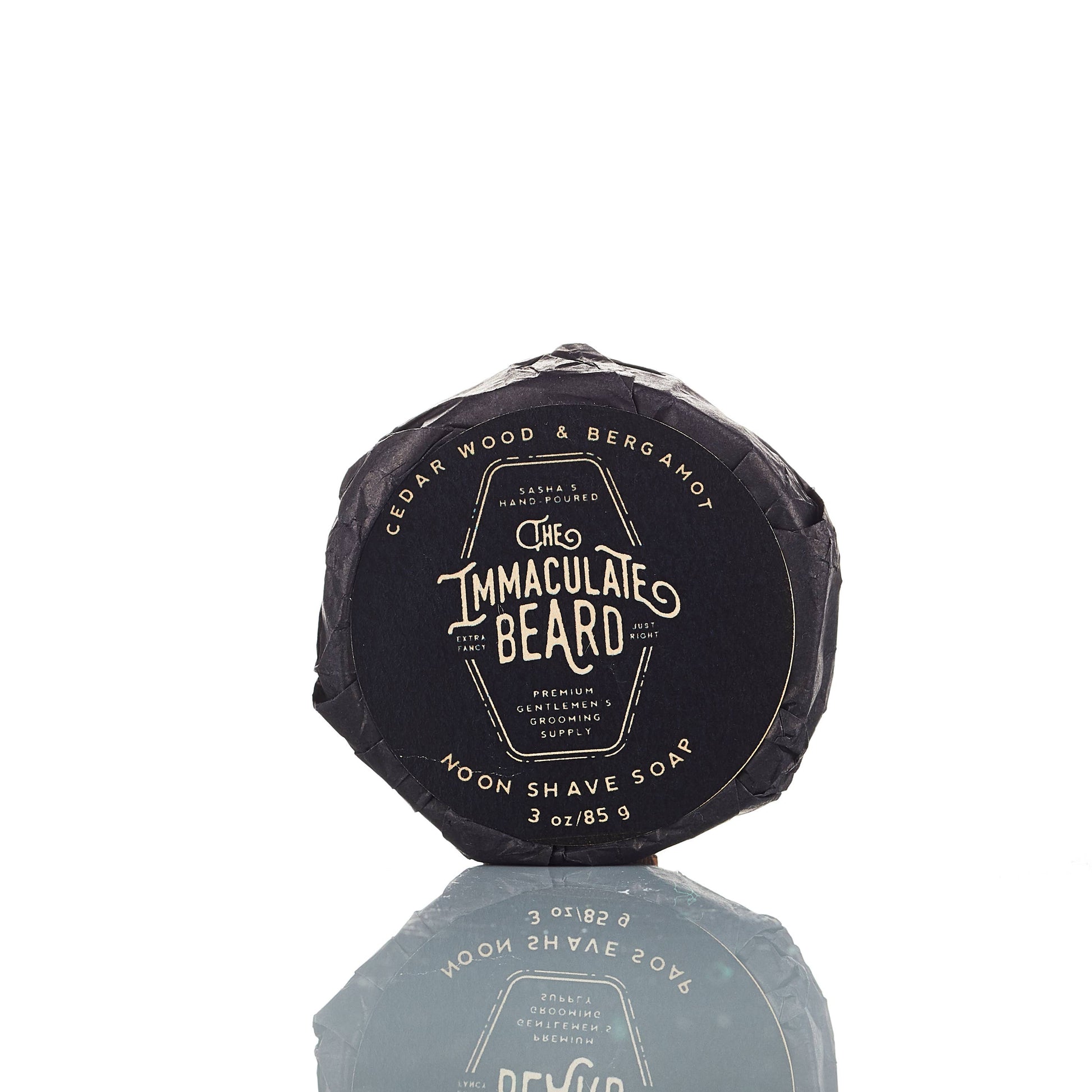 The Immaculate Beard shave soap puck in a round container, showing a smooth, creamy soap surface for grooming and shaving.